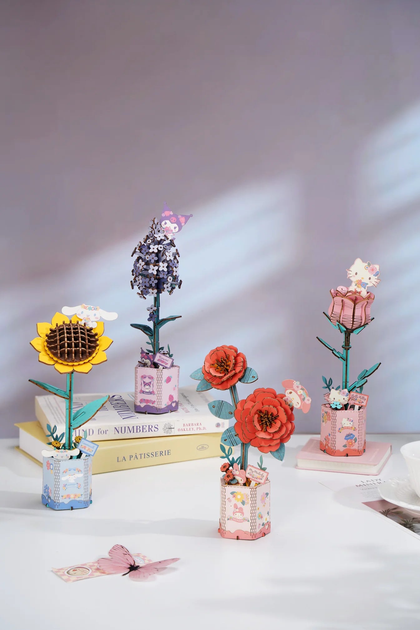 Hello Kitty® and Friends My Melody Red Camellia 3D Puzzle Kit with kawaii tags on pastel bases, ideal for creative assembly.