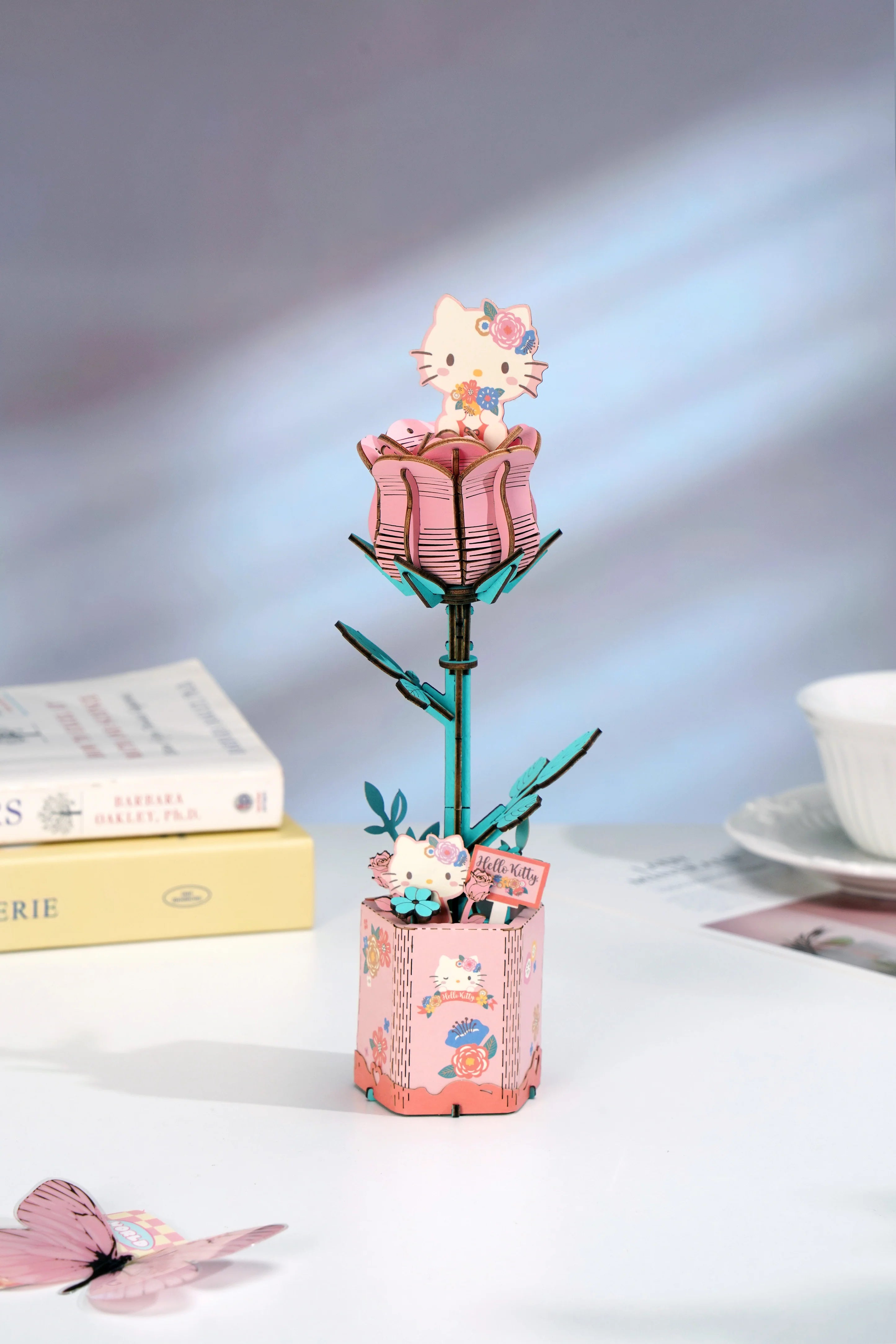 Hello Kitty® Pink Rose 3D Puzzle Kit with a Hello Kitty figure emerging from a wooden rosebud, designed for display or gifting.
