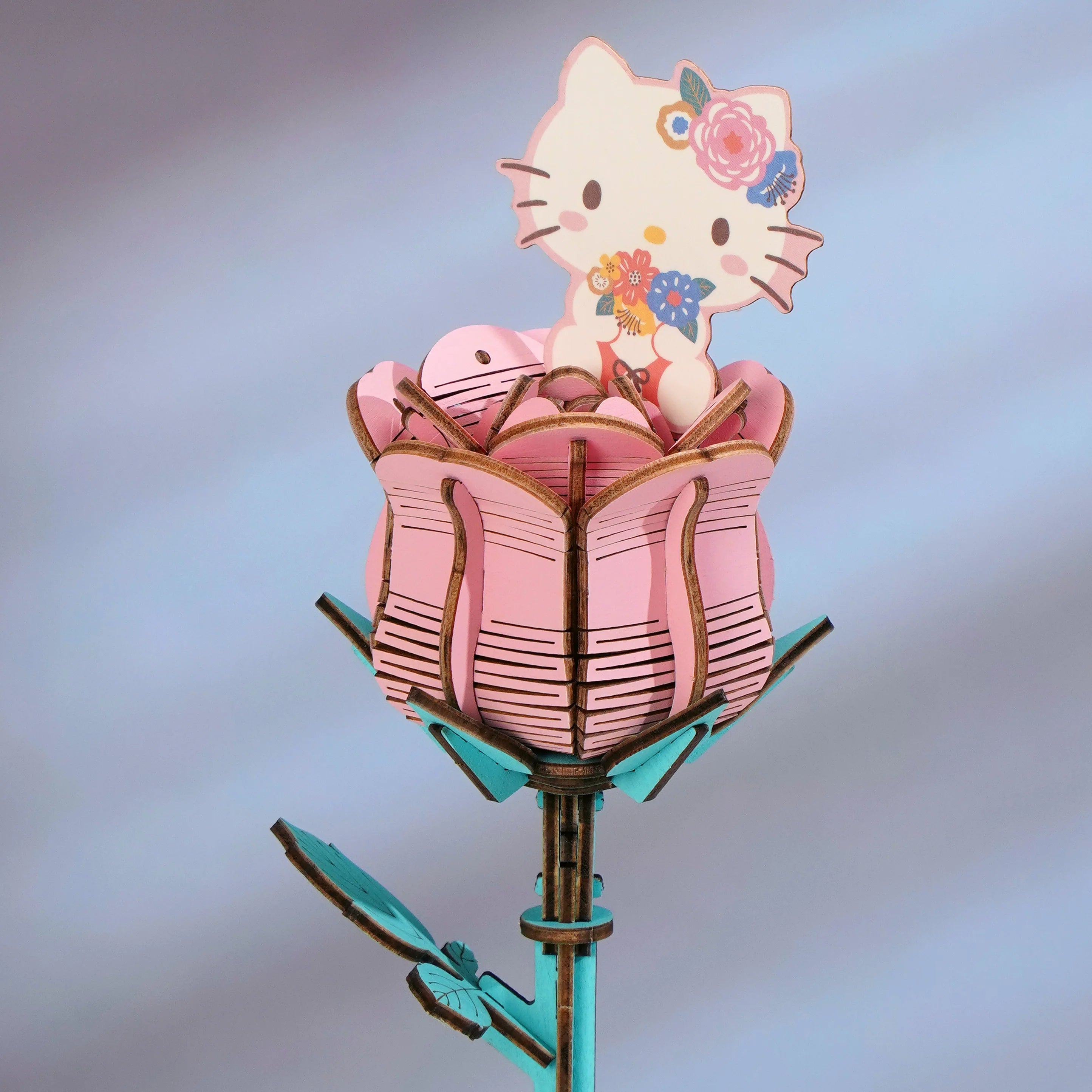 Hello Kitty Pink Rose 3D Wooden Puzzle Kit, featuring a pastel pink rose with a Hello Kitty topper, ideal for creative assembly and display.