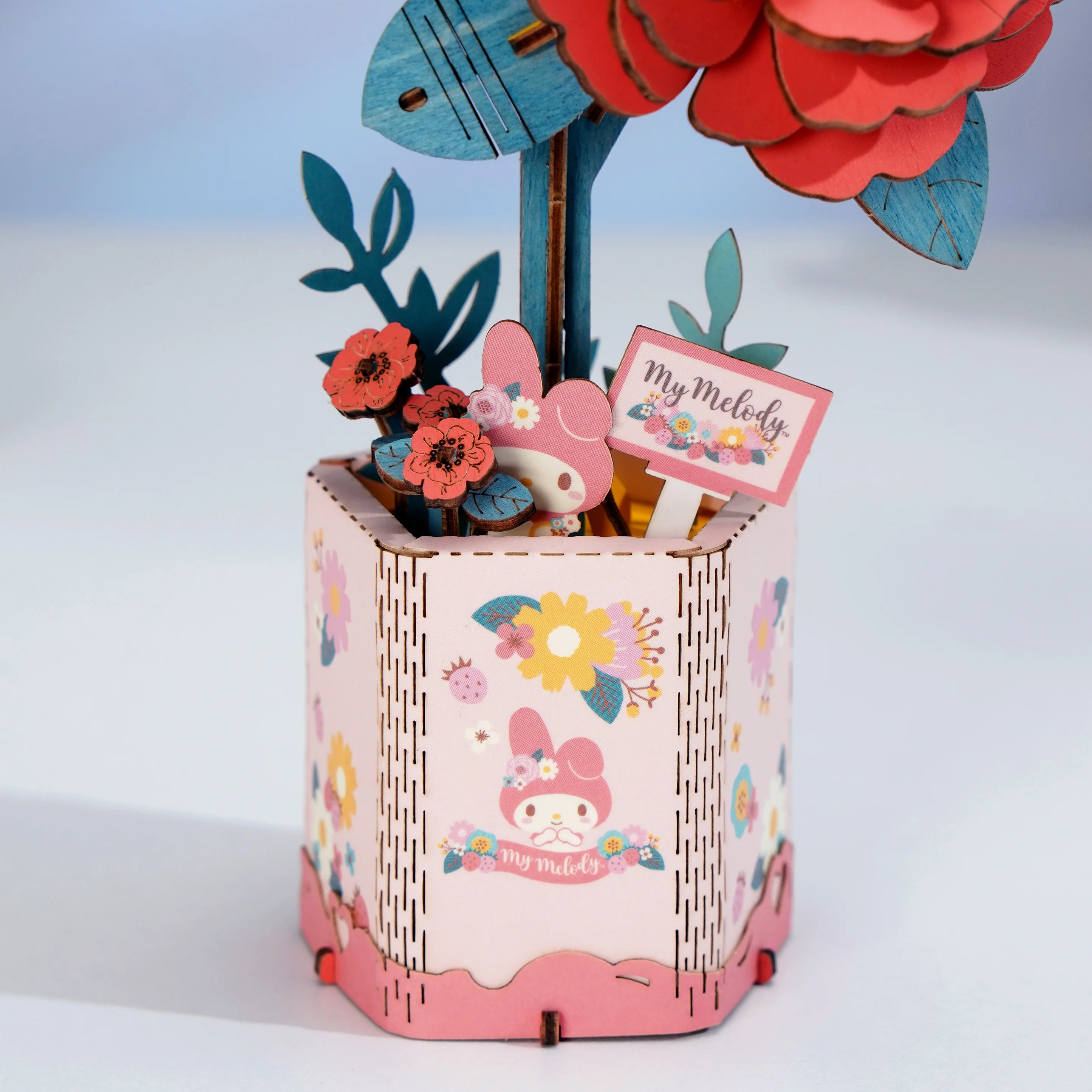 My Melody Red Camellia 3D Puzzle Kit in a pink octagonal planter, featuring a layered floral display with My Melody character and floral motifs.