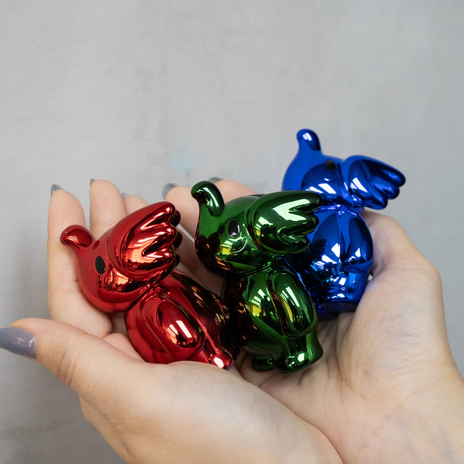 Elfie Eve 100% Xmas Edition figurines held in hand, showcasing the soft vinyl design and 3 size from Too Natthapong & Unbox Industries.