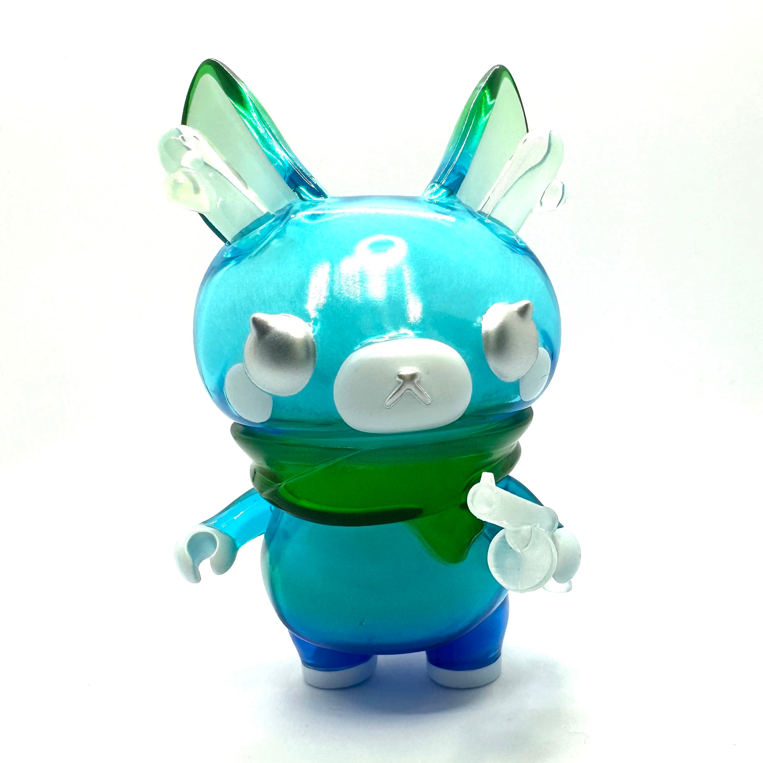 A close-up of Momiji-chan Blue Pond toy by Asako Hashi, a cartoon deer figure with a vinyl doll companion on an adventure in Hokkaido.