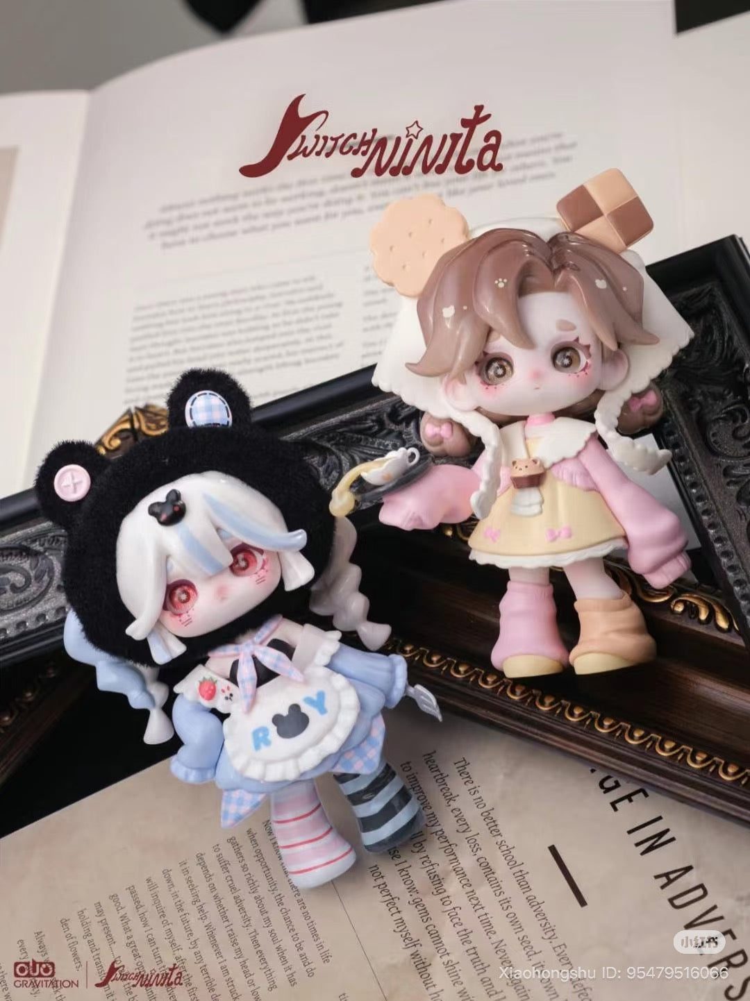 Ninita Magic Mirror Paradise Series Blind Box features chibi figures: one in a bear-ear hood, the other in a biscuit-themed cape, posed on an open book.
