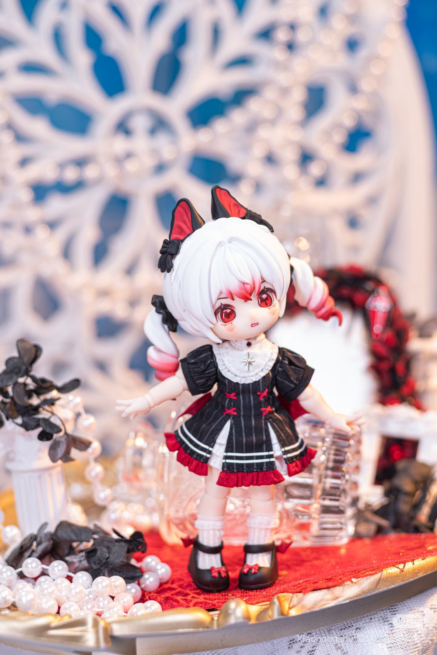 NAGI: The Phantom Record Series Articulated Figure, featuring gothic-Lolita attire and twin pigtails, elegantly posed with ornate props on a decorative tray.