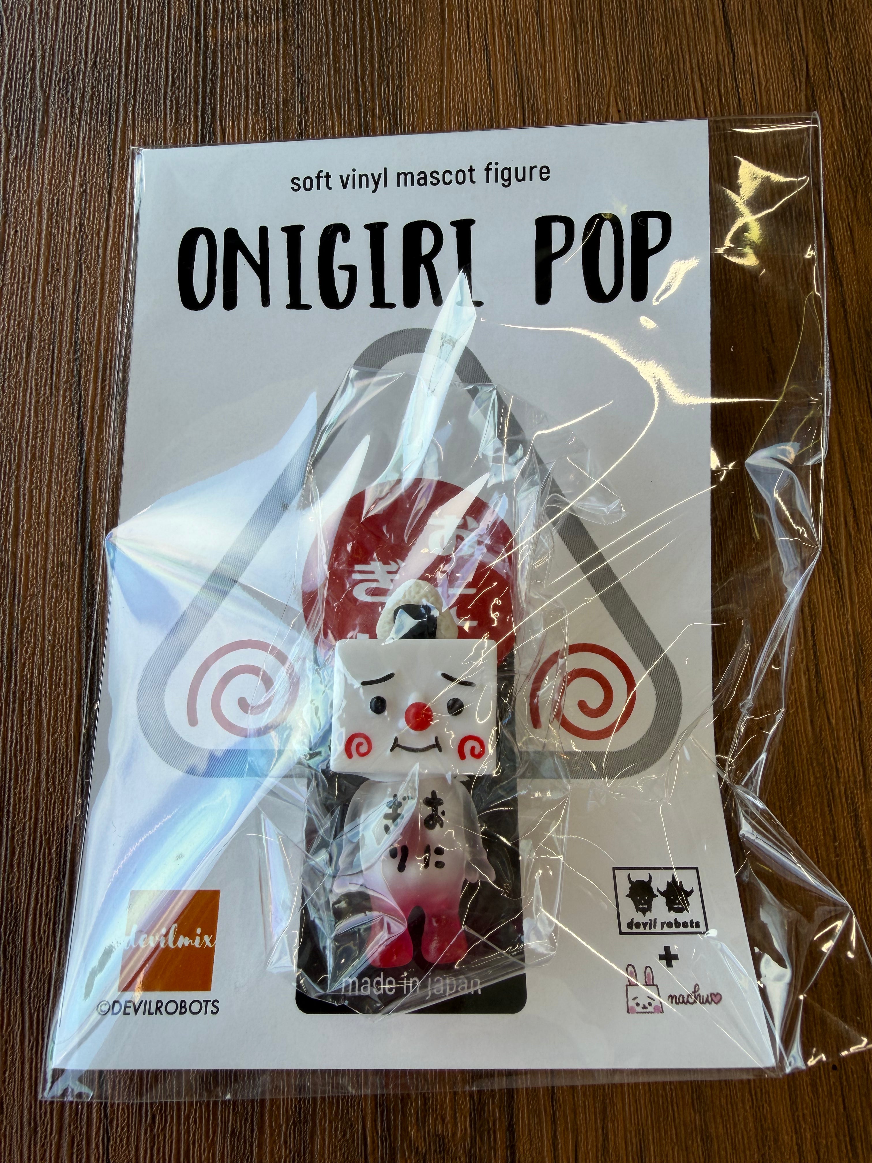 Mini To-fu - Onigiri Pop by Devil Robots: A 5cm sofubi rice-ball mascot with a face, red cheeks, and nori hat, in sealed packaging.