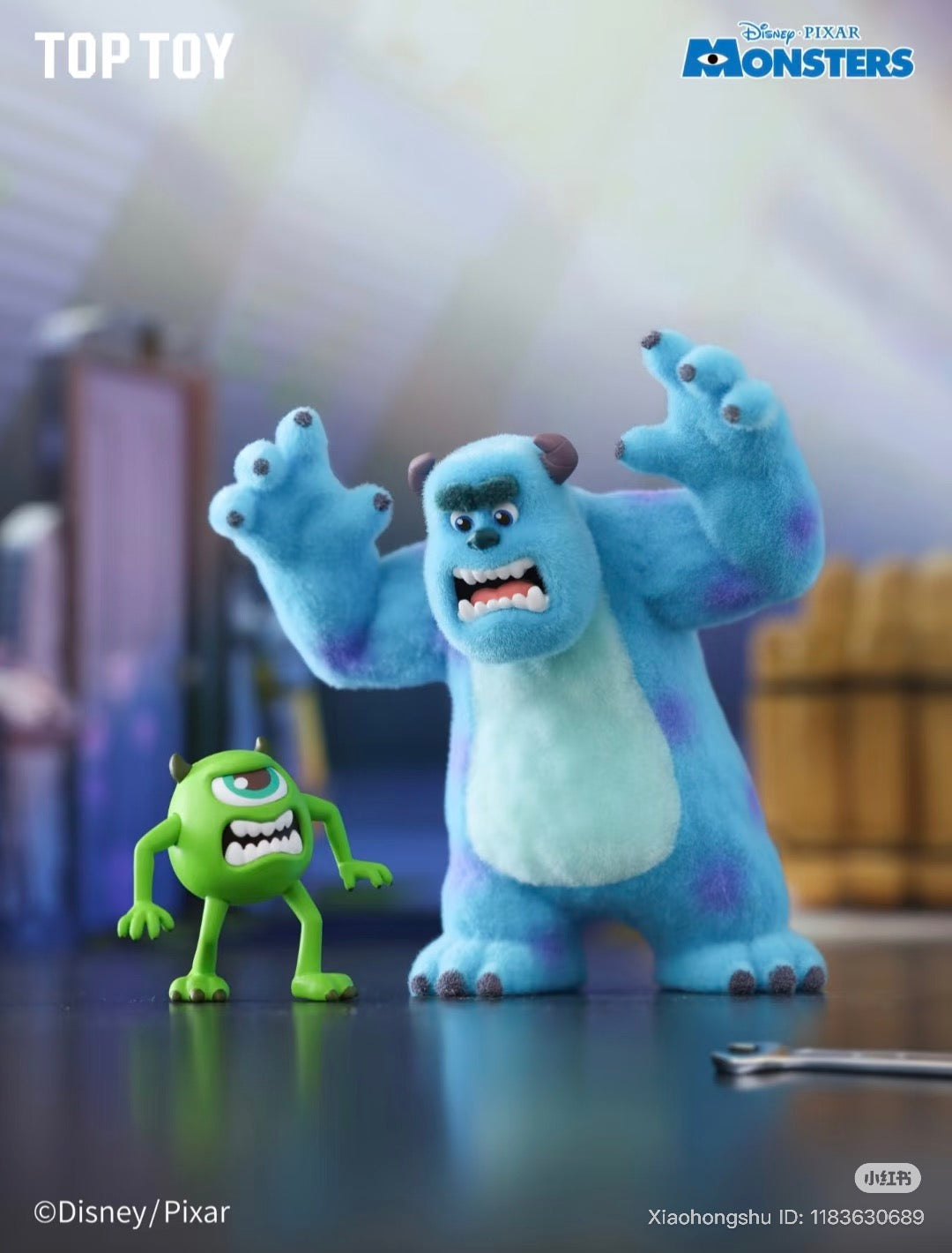 Disney Pixar Monsters, Inc. Series “Work Log” Blind Box featuring miniature Sulley and Mike Wazowski, posed with snarling faces on a tabletop.