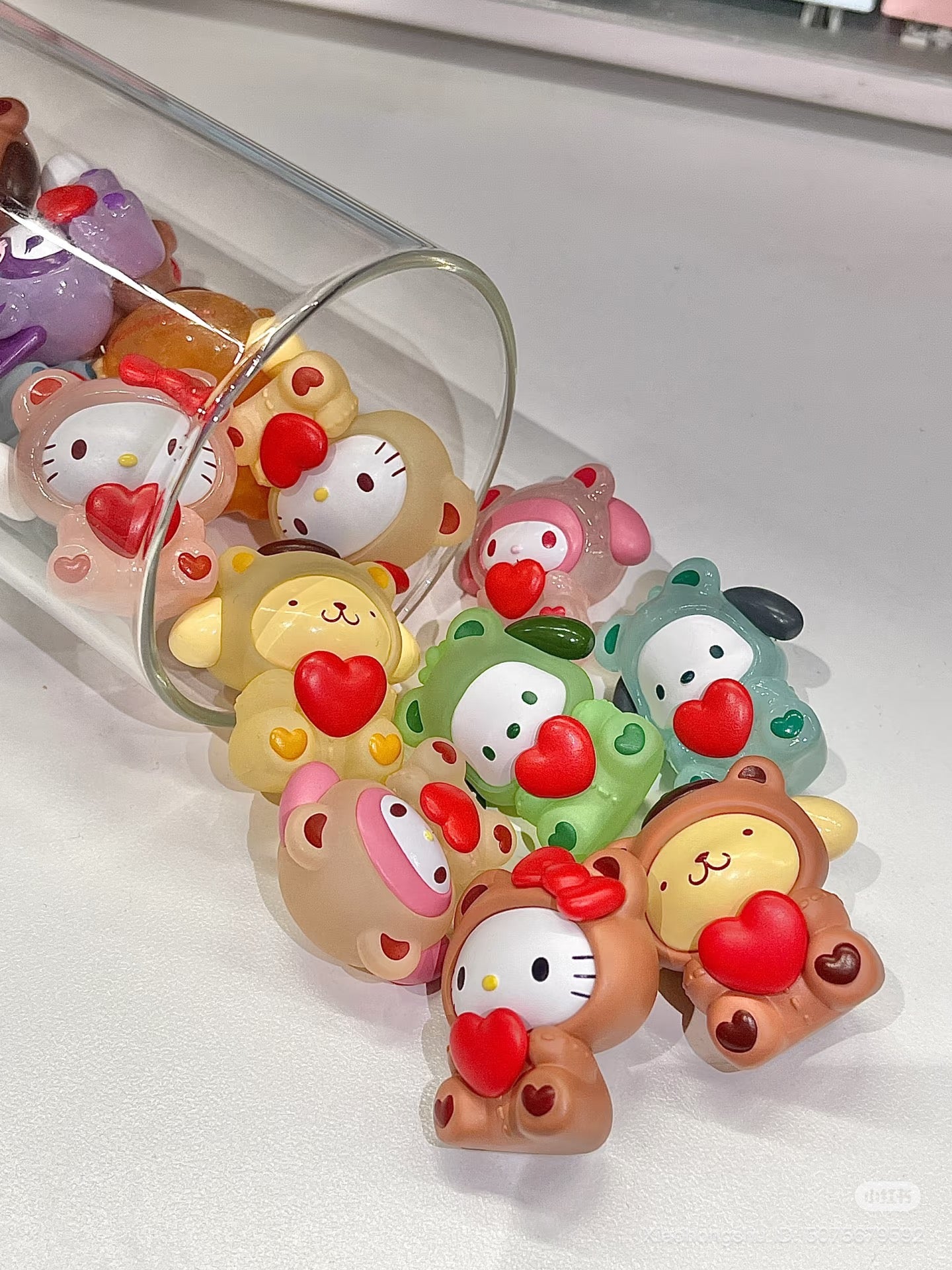 Sanrio Gummy Bears Blind Bag Bean Series figurines spill from a jar, featuring chibi animals with hearts. Preorder for November 2025 release.