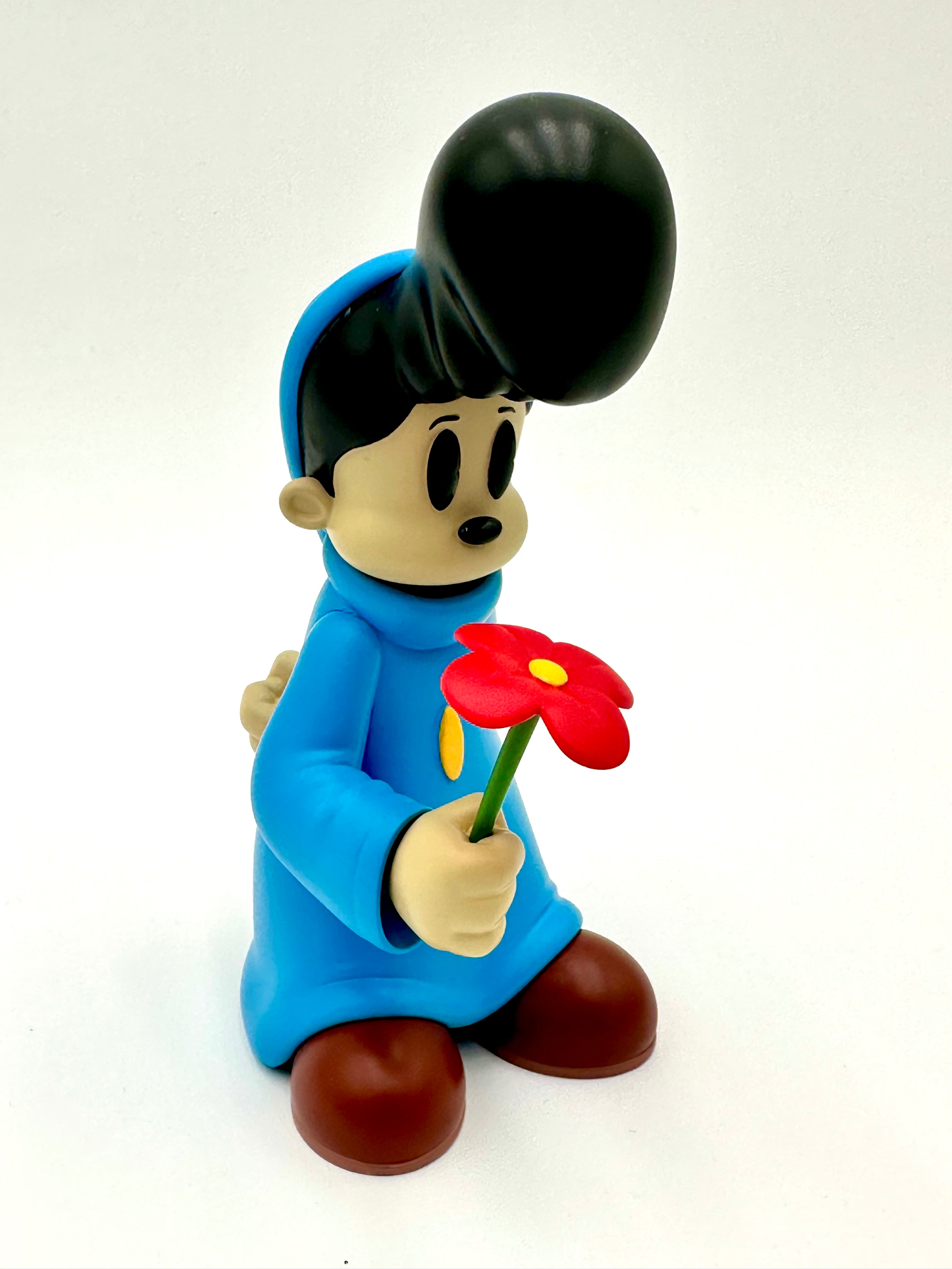 Before I Go by Ezra Brown: A 6-inch resin art toy with a black pompadour, blue tunic, and red flower, embodying a whimsical, collectible design.