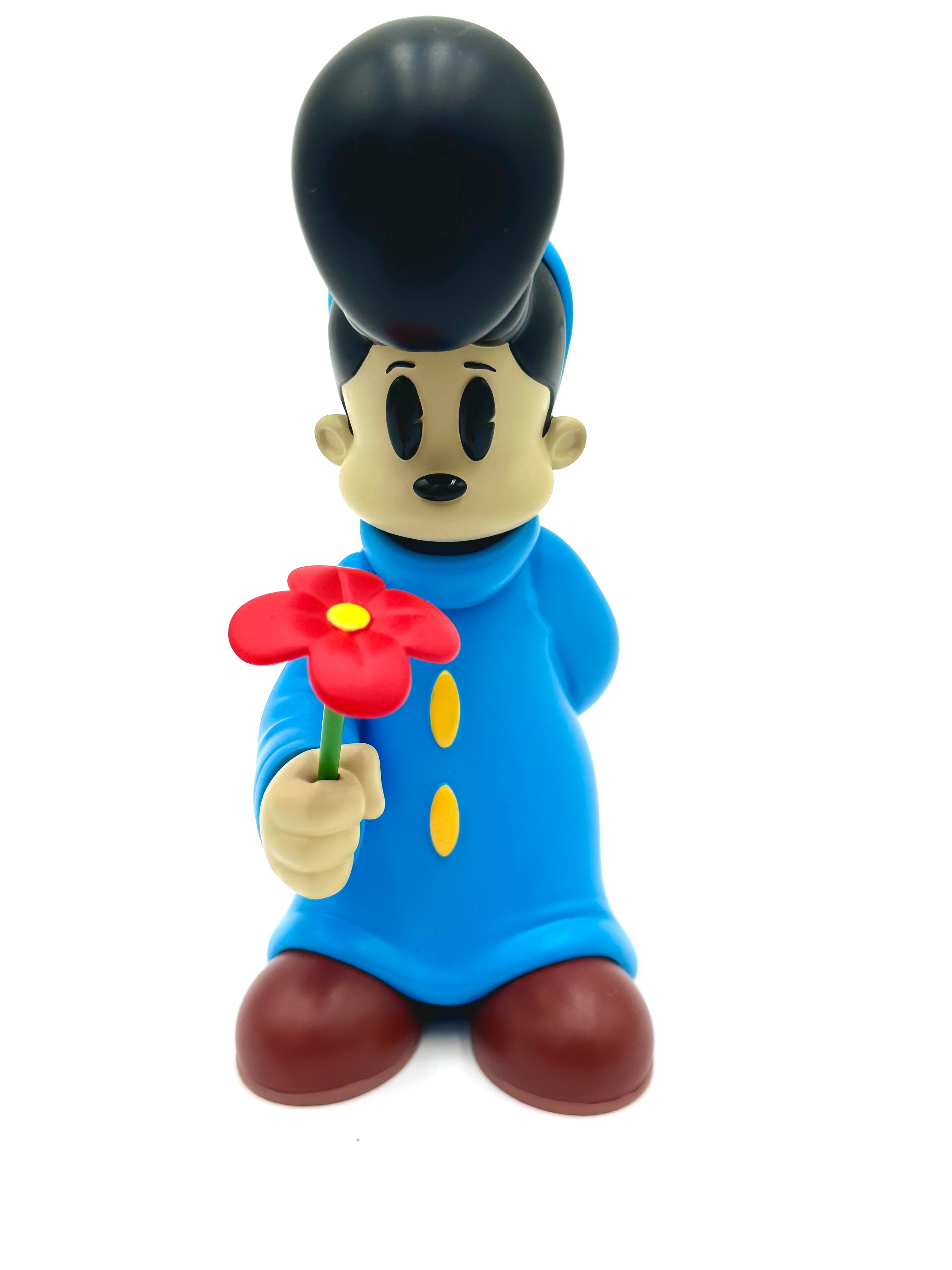 Vinyl figurine Before I Go by Ezra Brown, 6-inch resin, features minimalist design with blue coat, pompadour hairstyle, and extended arm holding a single red flower.