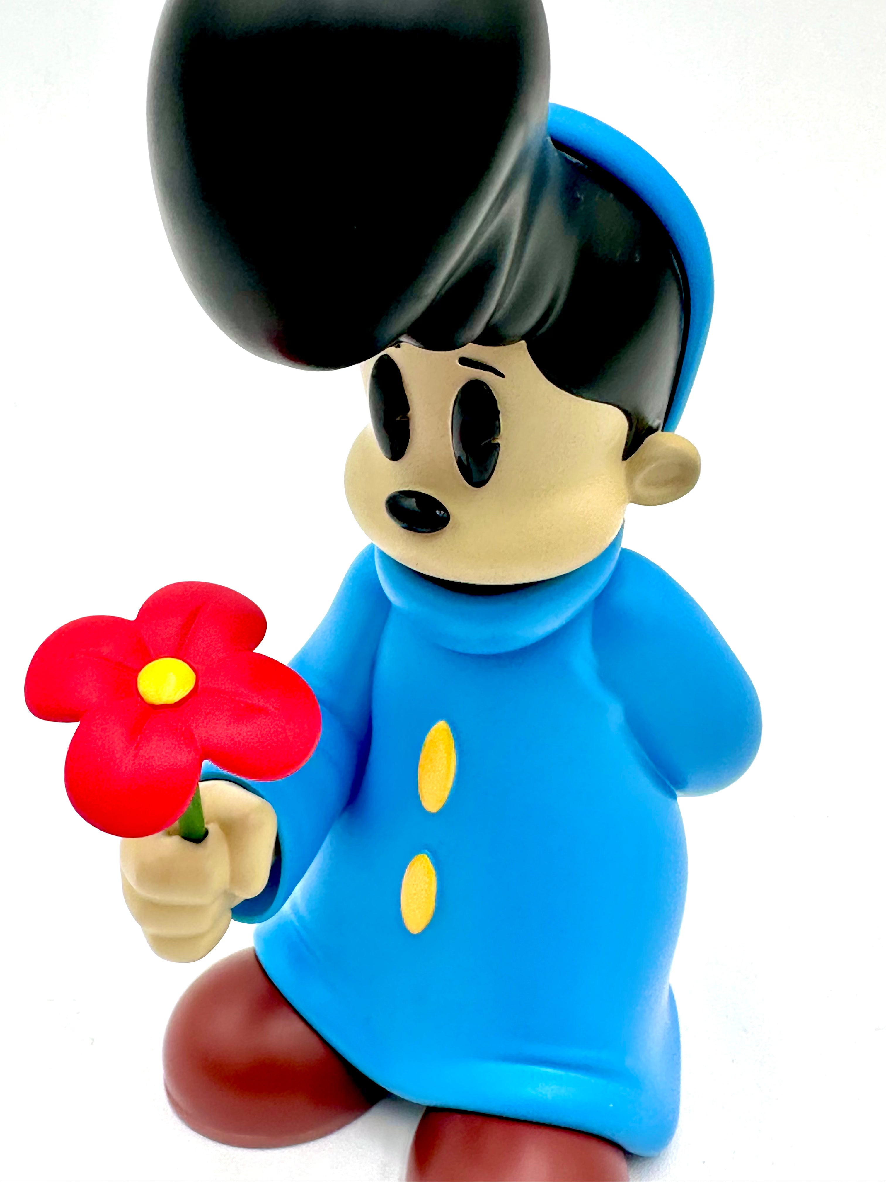 Vinyl toy Before I Go by Ezra Brown, a 6-inch resin figure in a blue coat holding a red flower.