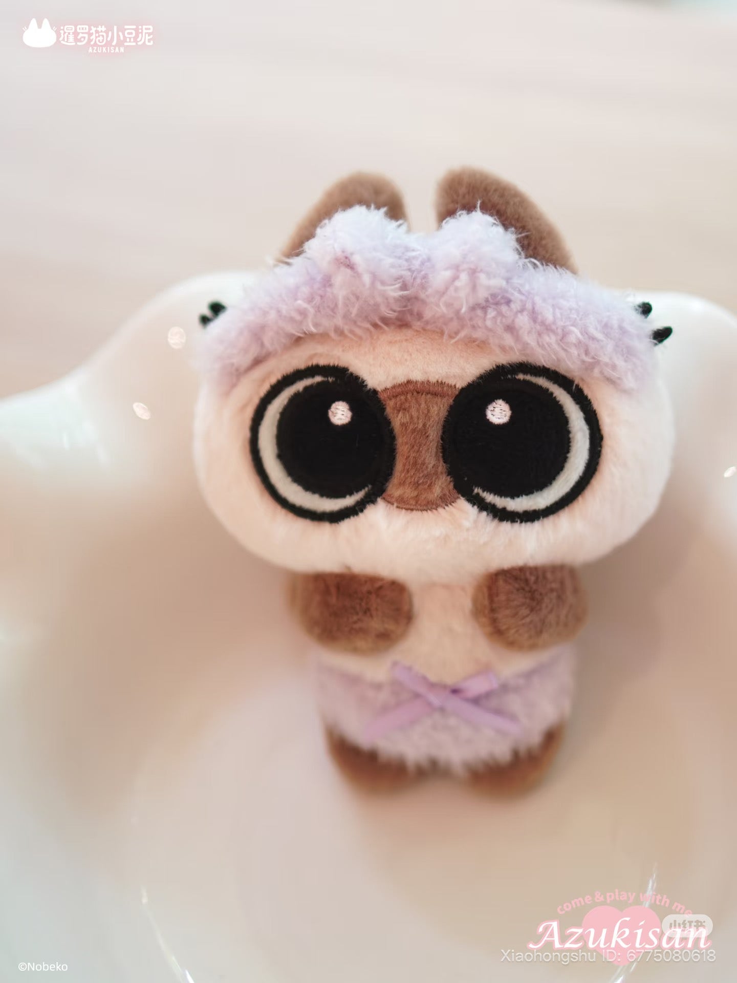 Azukisan's Daily Life Series plush pendant in lilac attire, featuring embroidered eyes, cream fur, and branding, available for preorder in a blind box set.