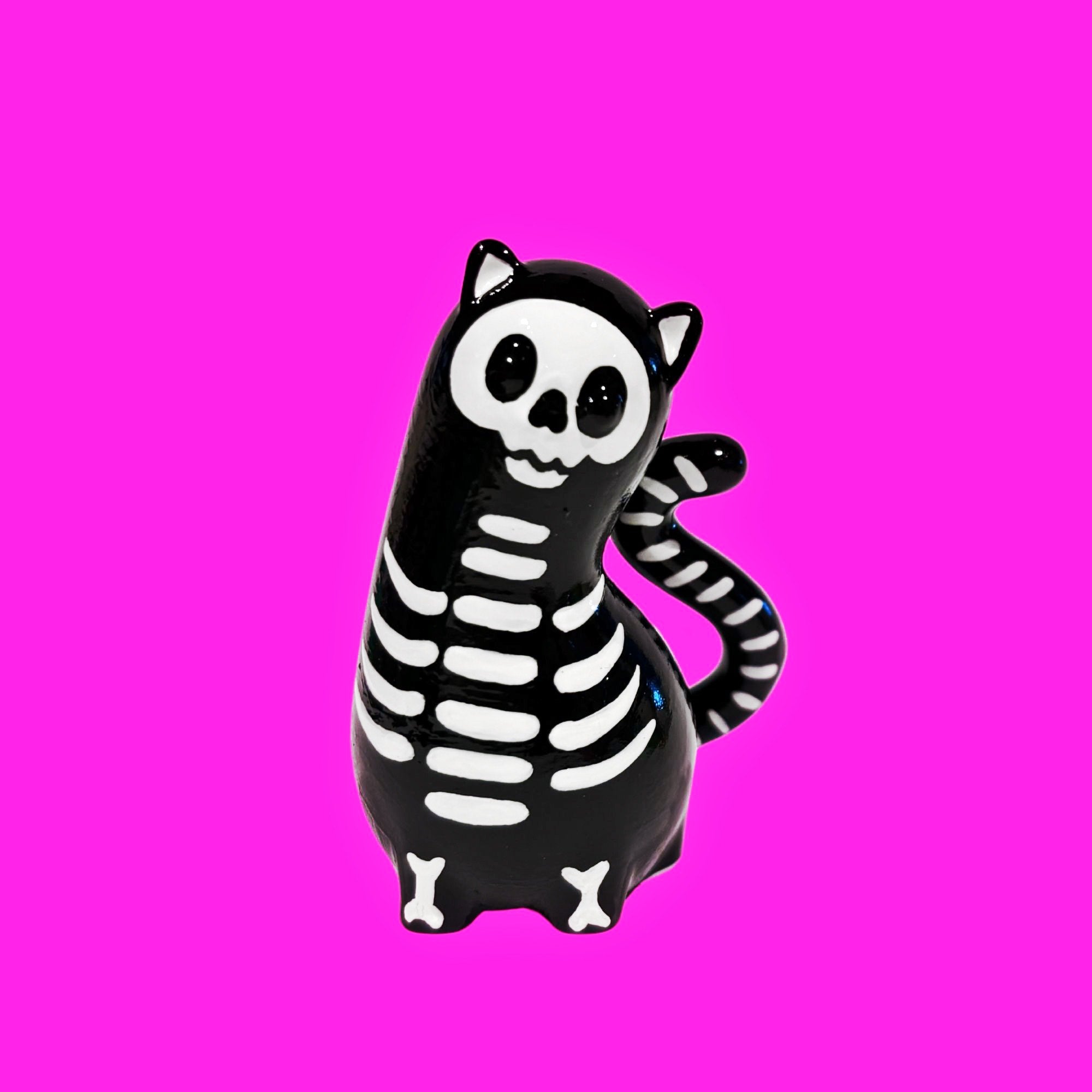 Spencer by Ghost Fox Toys: A glossy black resin cat figurine with white skeleton details, designed as an art toy or ornament.