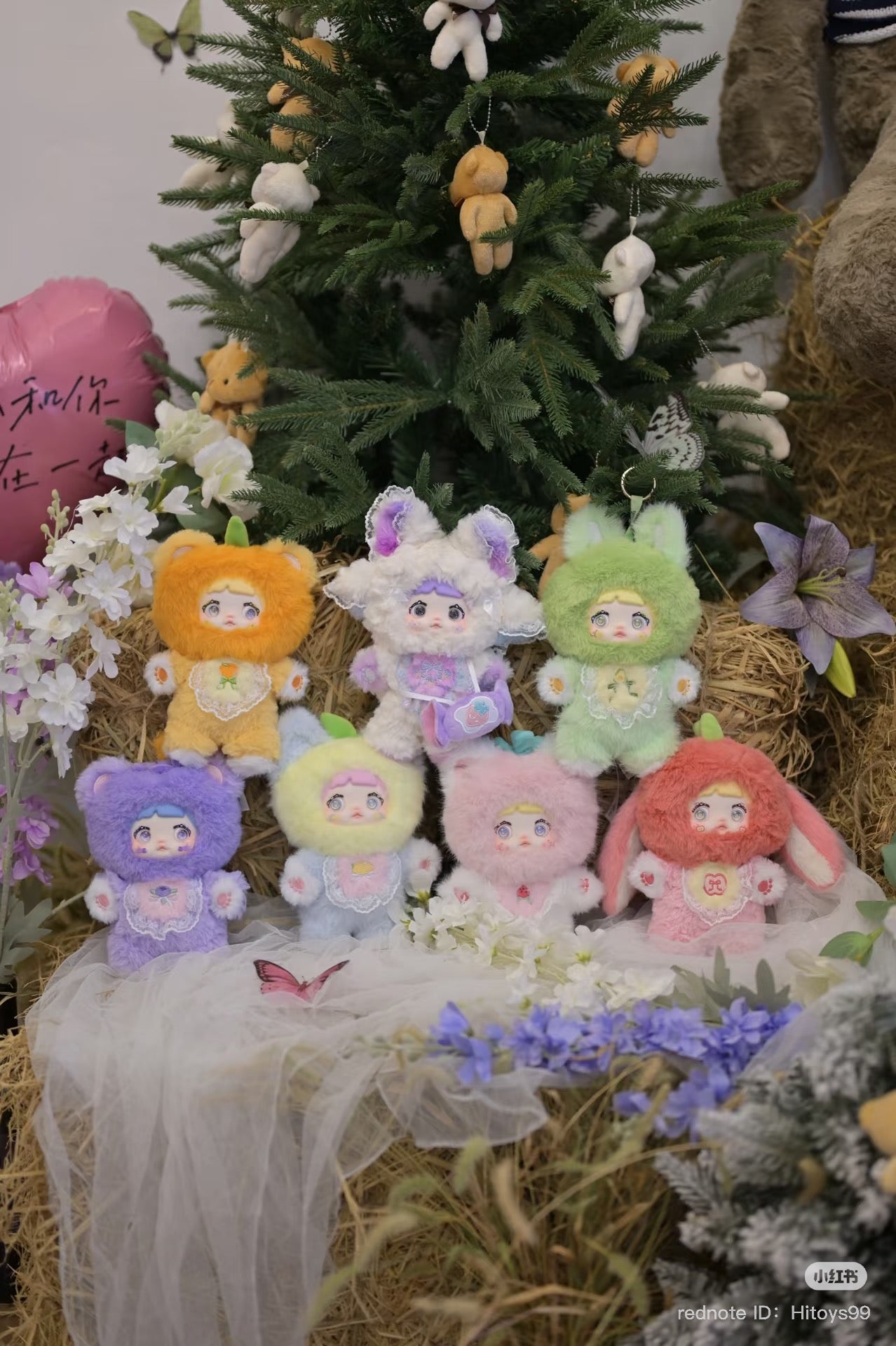 Nommi Interesting Fruit Series Plush Blind Box featuring various stuffed animals, including a secret design, displayed by a Christmas tree.