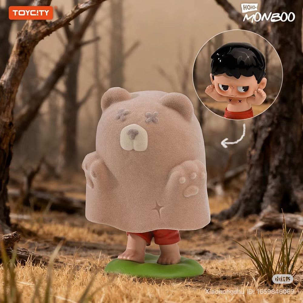 MONBOO-Guardian Of The Homeland Series Blind Box: A vinyl figure of a child in red shorts under a bear-shaped ghost blanket, standing on a leaf base.