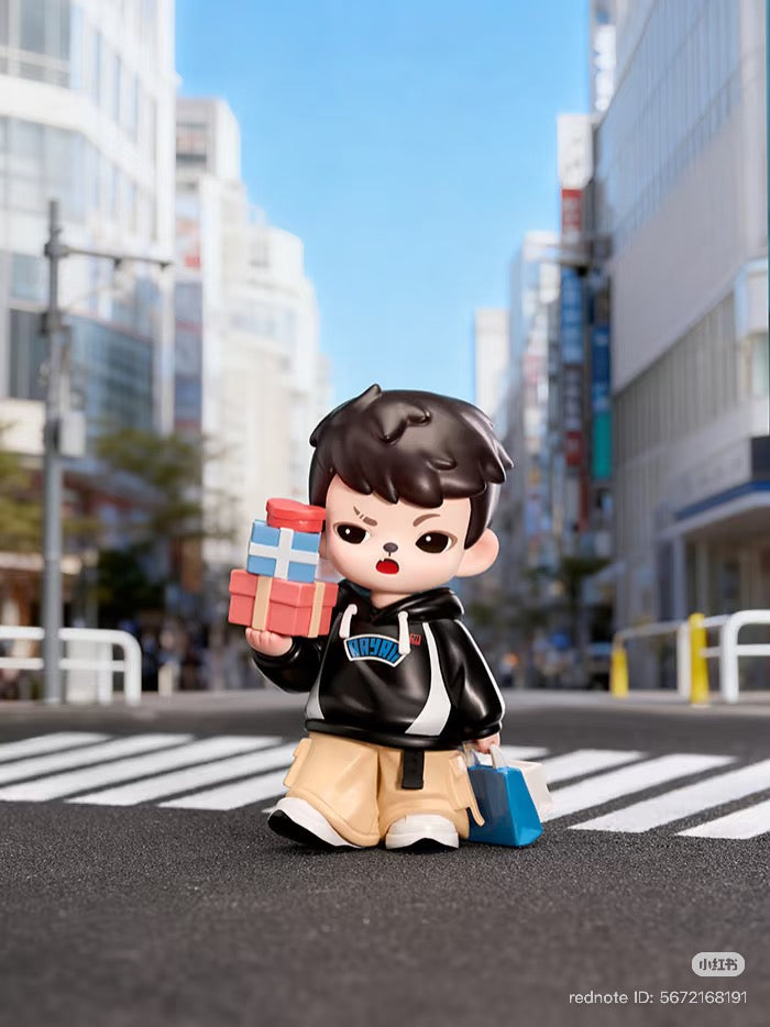 Rayan Let't Date Series figure of a boy with gifts, in a city crosswalk. Preorder for a chance at regular or secret design.