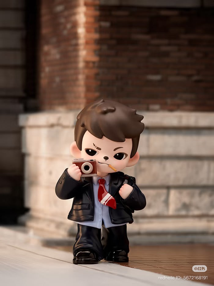 Chibi-style figurine from Rayan Let't Date Series, depicting a boy photographer with camera, part of a blind box collection by Strangecat Toys.