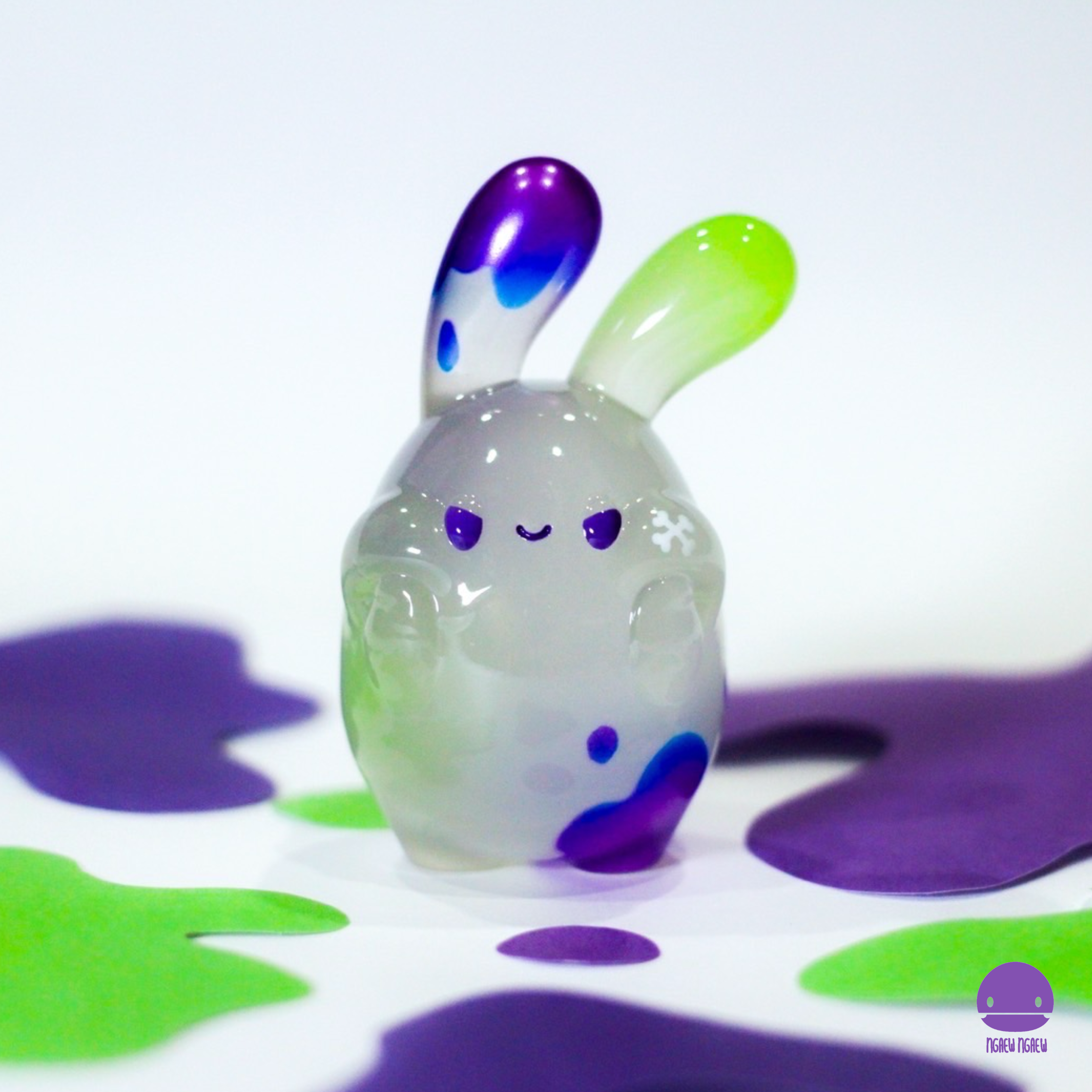 A glass bunny figurine with blue and green ears, part of Ngaew ngaew Chubby Bubble(Poison) by Ngaew Ngaew - Preorder.