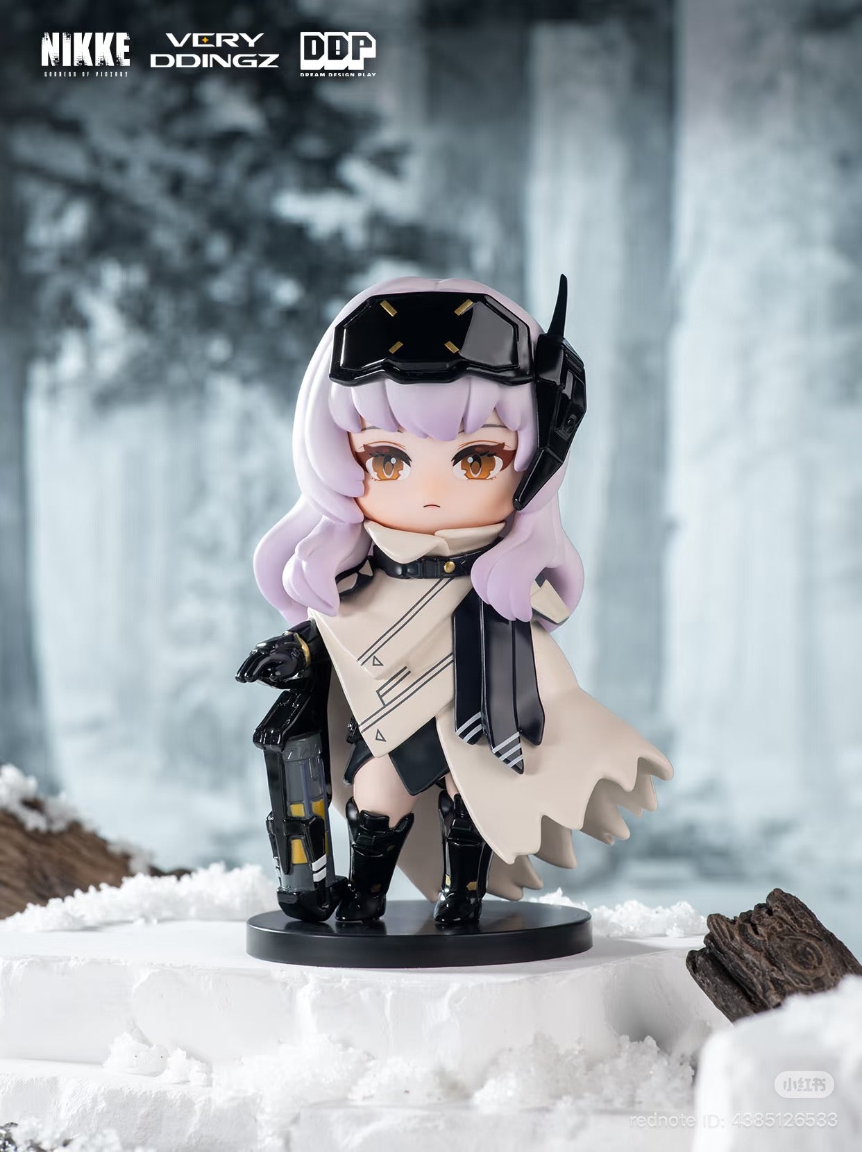 Chibi collectible figure from NIKKE: Goddess of Victory Blind Box, featuring lavender hair, futuristic attire, and a sci-fi weapon, posed against a snowy backdrop.