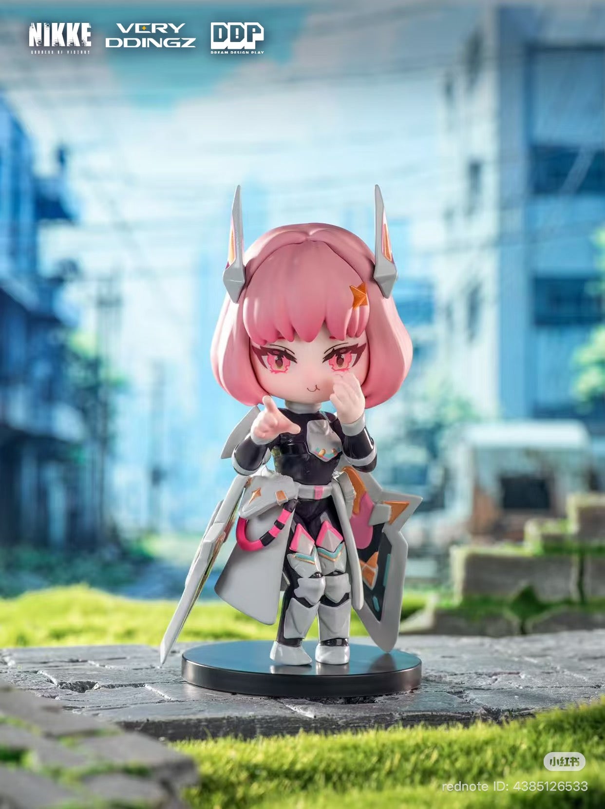 NIKKE: Goddess of Victory Blind Box features a pink-haired chibi figurine in futuristic armor, holding a sword and shield, from the mobile game collaboration.
