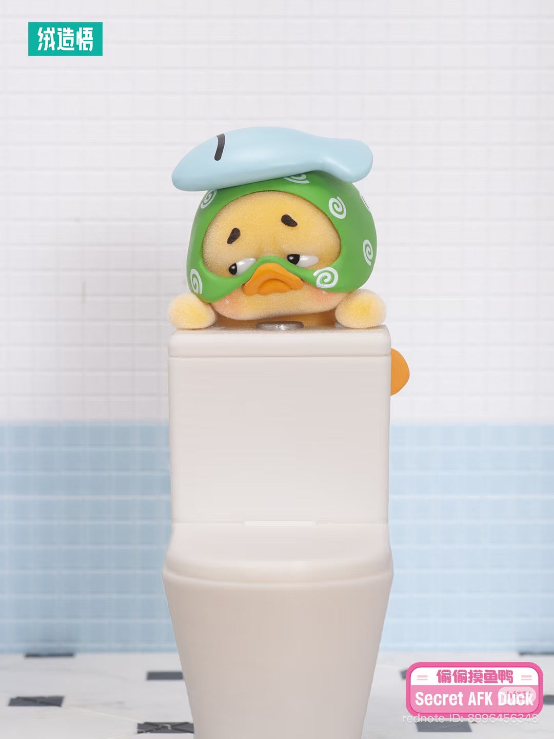 Upsetduck Status Display Duck Blind Box figurine featuring a fuzzy yellow duck with a green headwrap, perched on a white surface, branded as Secret AFK Duck.