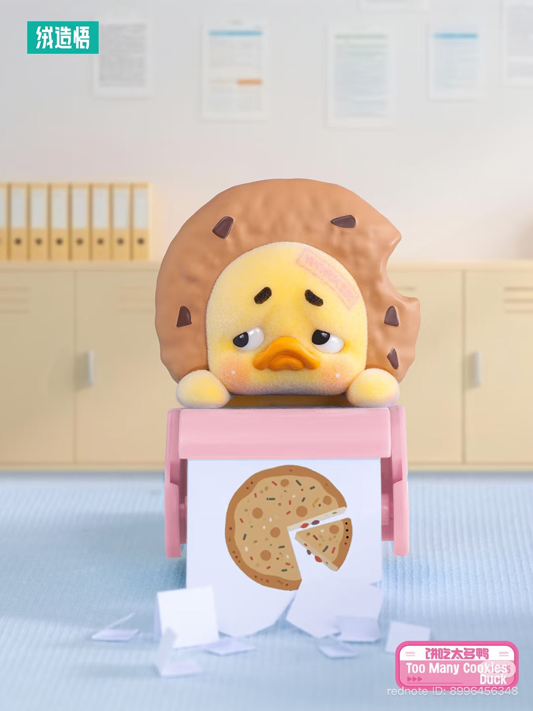 Upsetduck Status Display Duck Blind Box - Preorder: Cartoon duck with cookie ring on head, seated on pink stool, looking remorseful. Includes cookie sheet and scattered paper scraps.