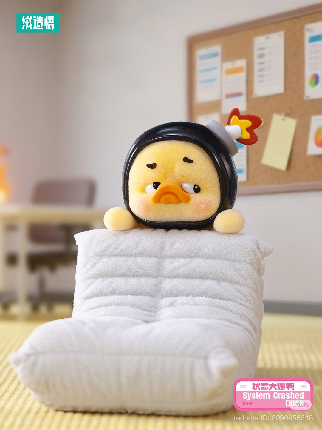 Upsetduck Status Display Duck Blind Box - Preorder: Plush yellow duck with helmet and rocket flame on cushion in home-office setting, branded System Crashed Duck.