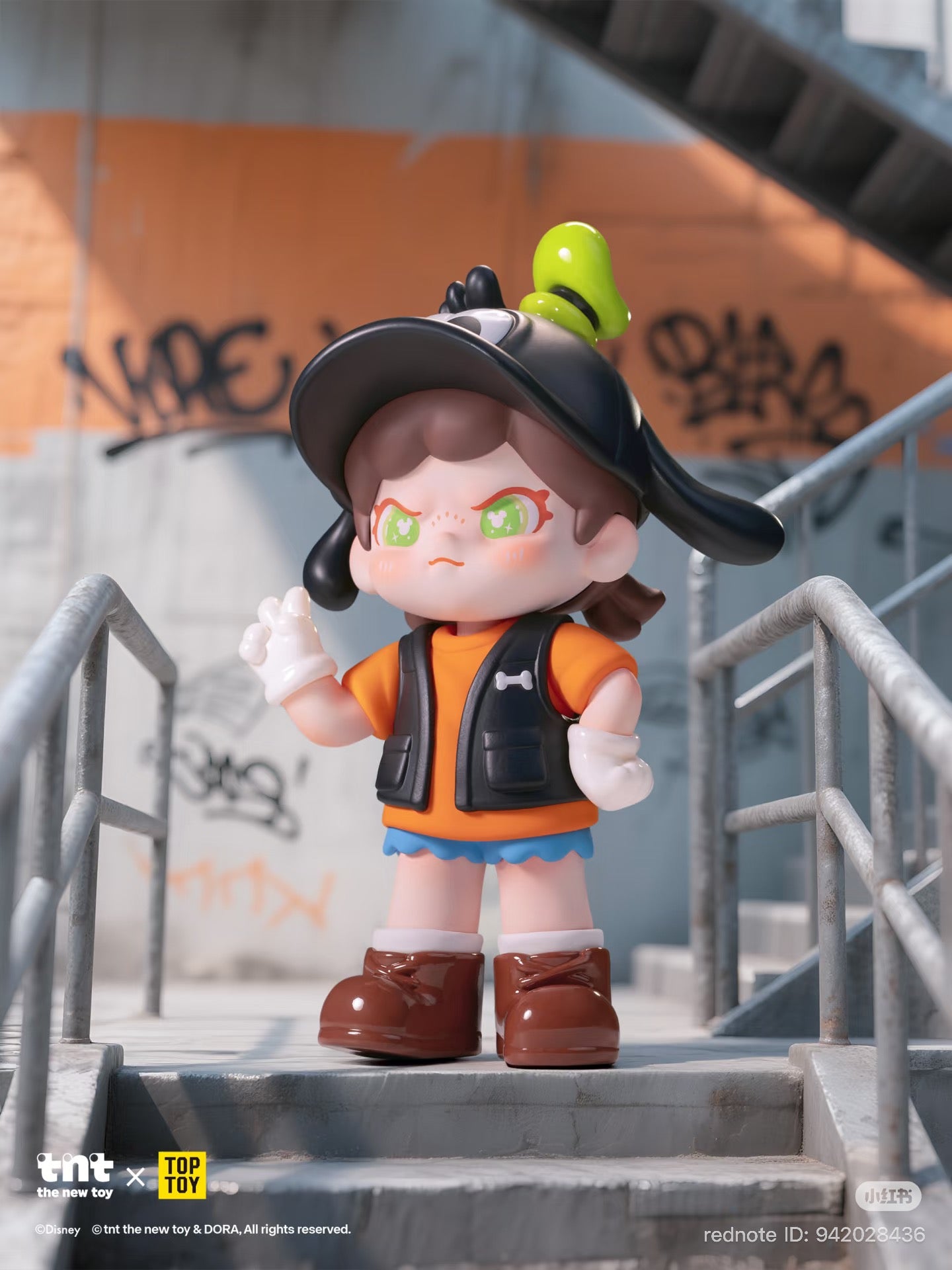 Disney DORA loves Mickey series figure: chibi girl in a black cap, orange T-shirt, and blue skirt, posed on graffiti-marked stairs.