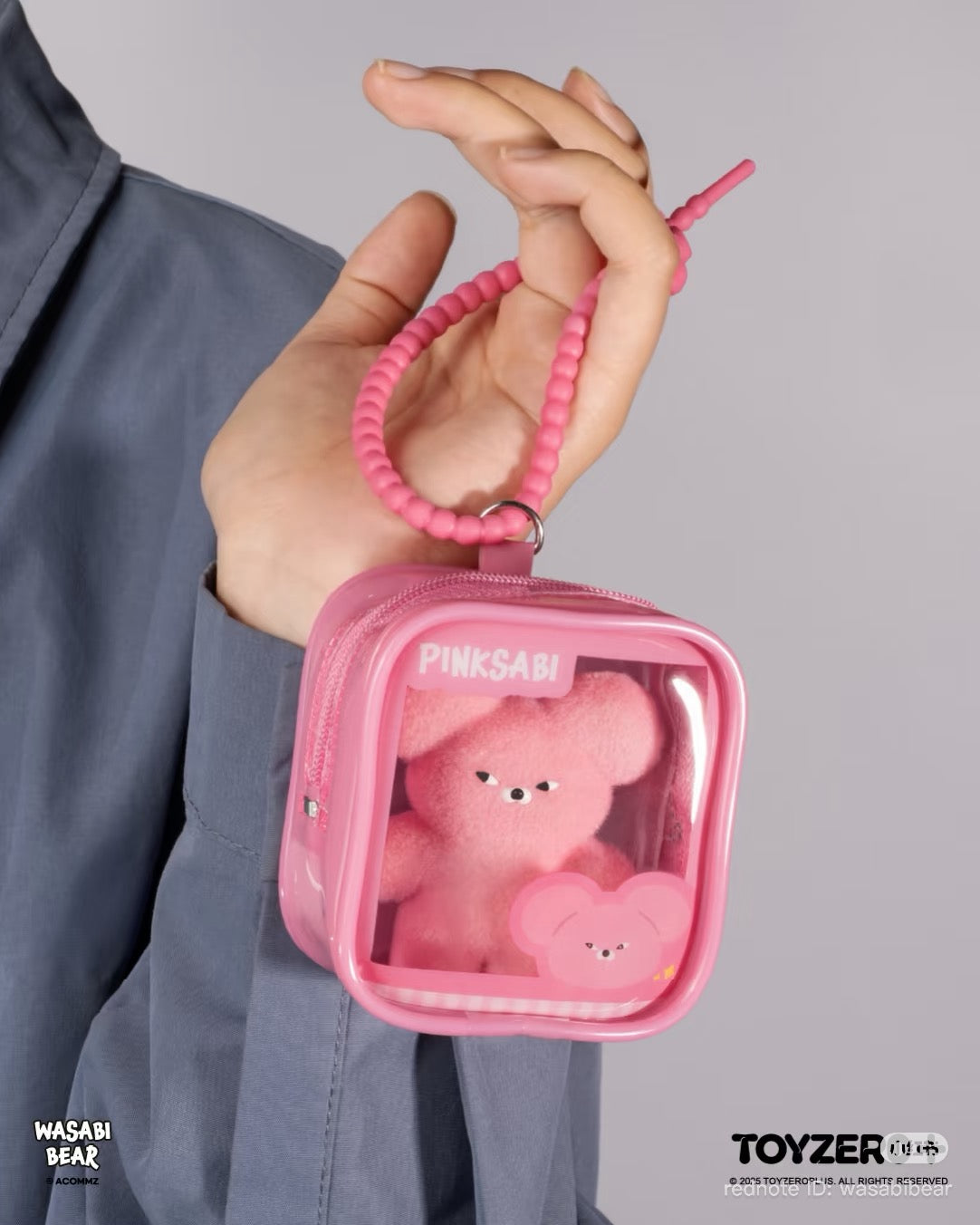 Wasabi Bear Outing Pals Series Blind Box features a pink plush bear in a clear-front pink pouch with a beaded wrist strap.