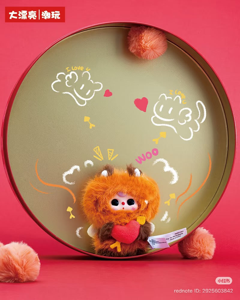 Baby Three - Cupid Plush Blind Box: Fuzzy orange-brown creature with horns, big eyes, clutching a red heart, surrounded by doodles and chalky text.