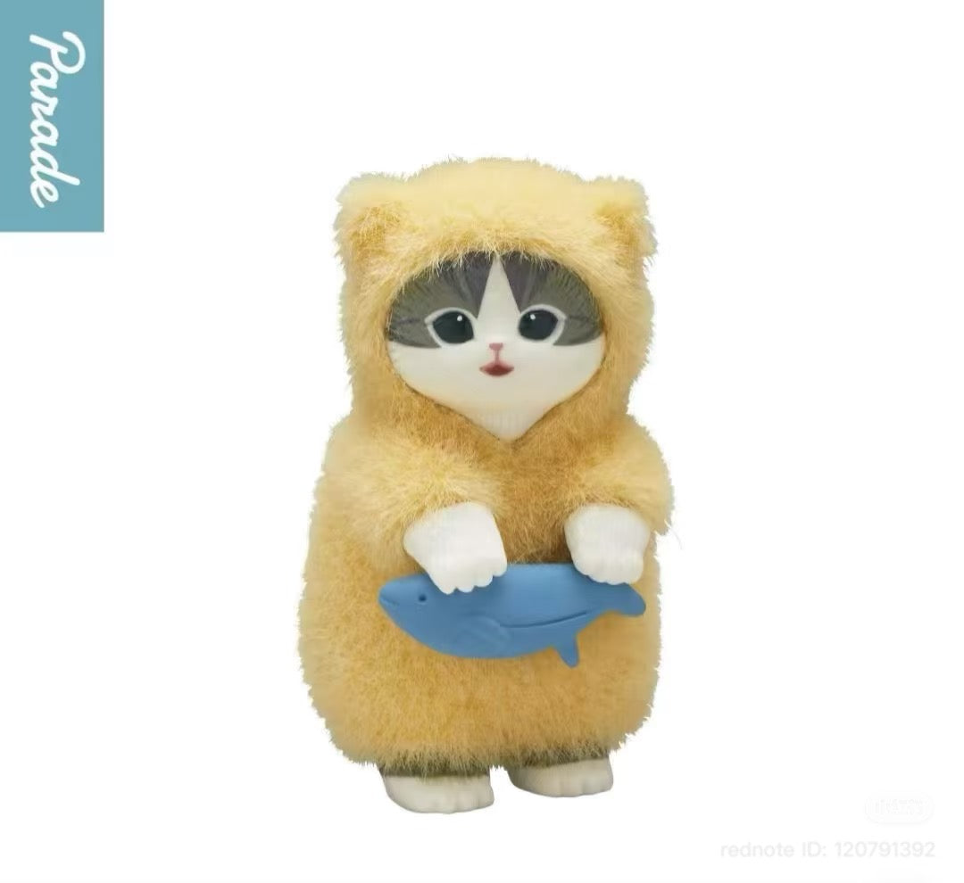 Mofusand Fluffy Pajama Figure Blind Box: Cat figurine in yellow costume holding a blue fish, part of a collectible toy series from Parade.