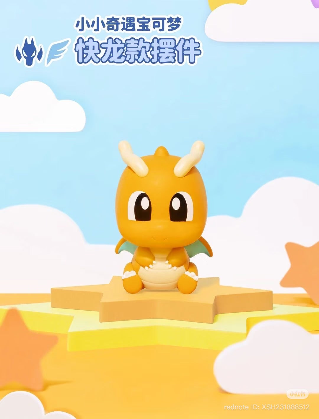 Chibi-style Dragonite figurine from Pokémon Mini Adventure Series 3, seated on a star pedestal, against a whimsical sky, with preorder details noted.