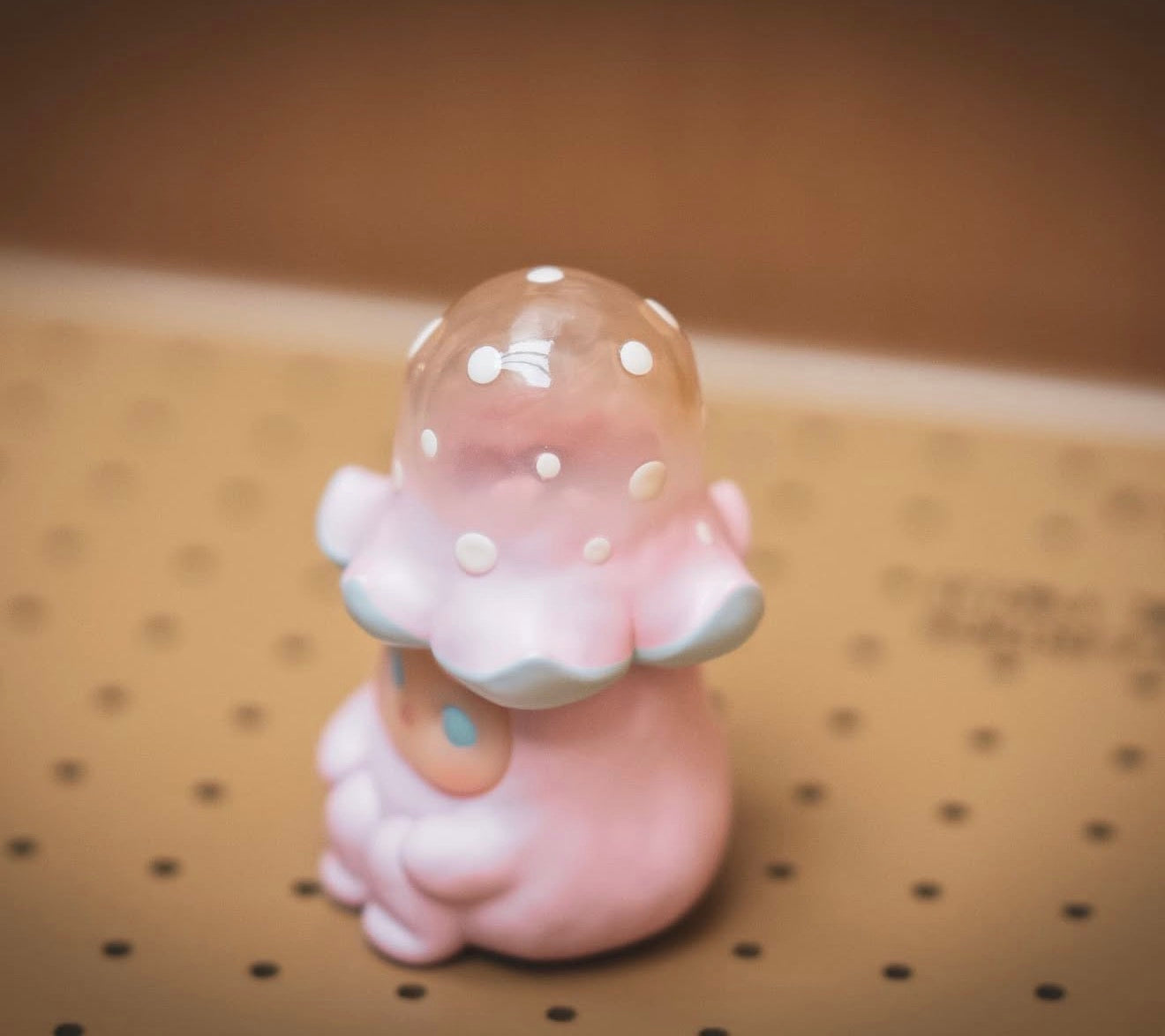 Pucky Mushroom Beanie - Tall Pink Hat: A pastel-pink vinyl art toy with a translucent polka-dotted dome helmet, available for preorder at Strangecat Toys.