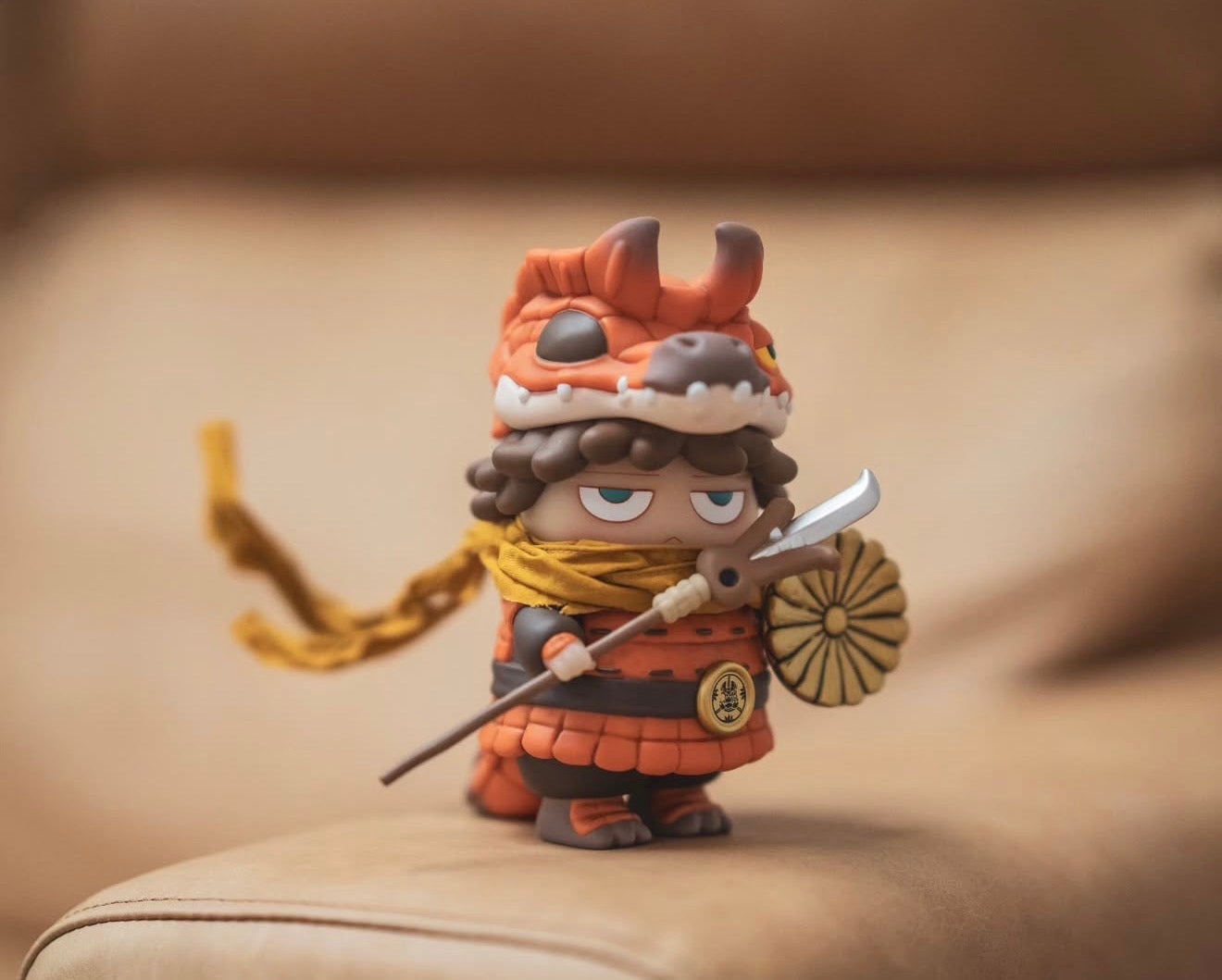 Poh x Booker Warrior figurine in chibi-style, featuring orange armor, dragon-head helmet, mustard scarf, holding spear and shield. Preorder, shipping by Jan 2026.