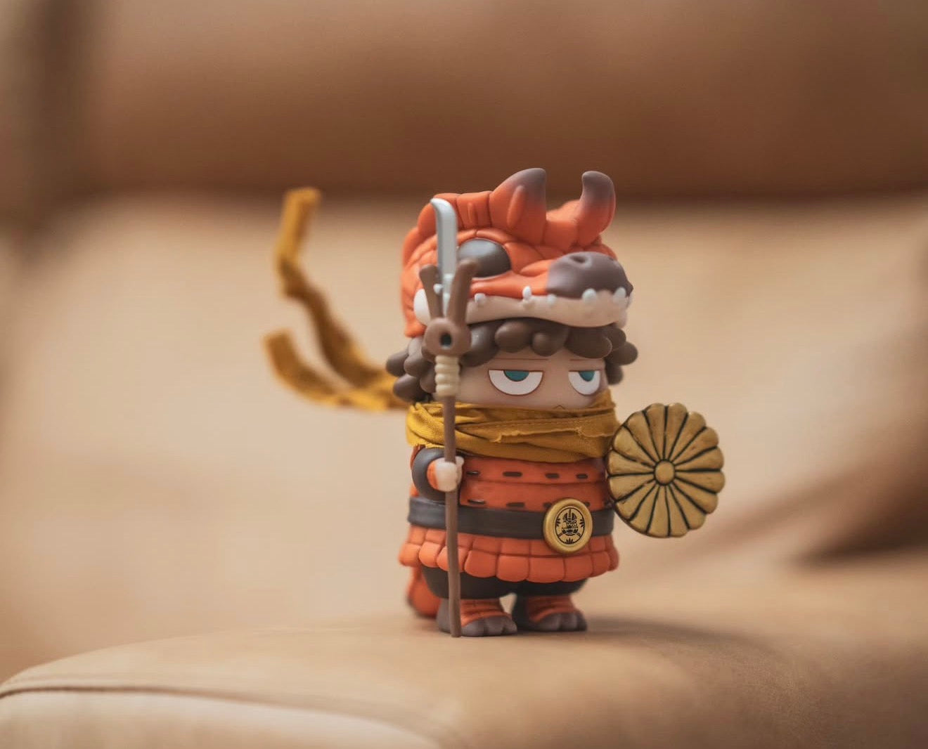 Poh x Booker Warrior figurine, chibi-style in orange dragon armor, holding a shield and spear. Preorder from Strangecat Toys, ships by Jan 2026.
