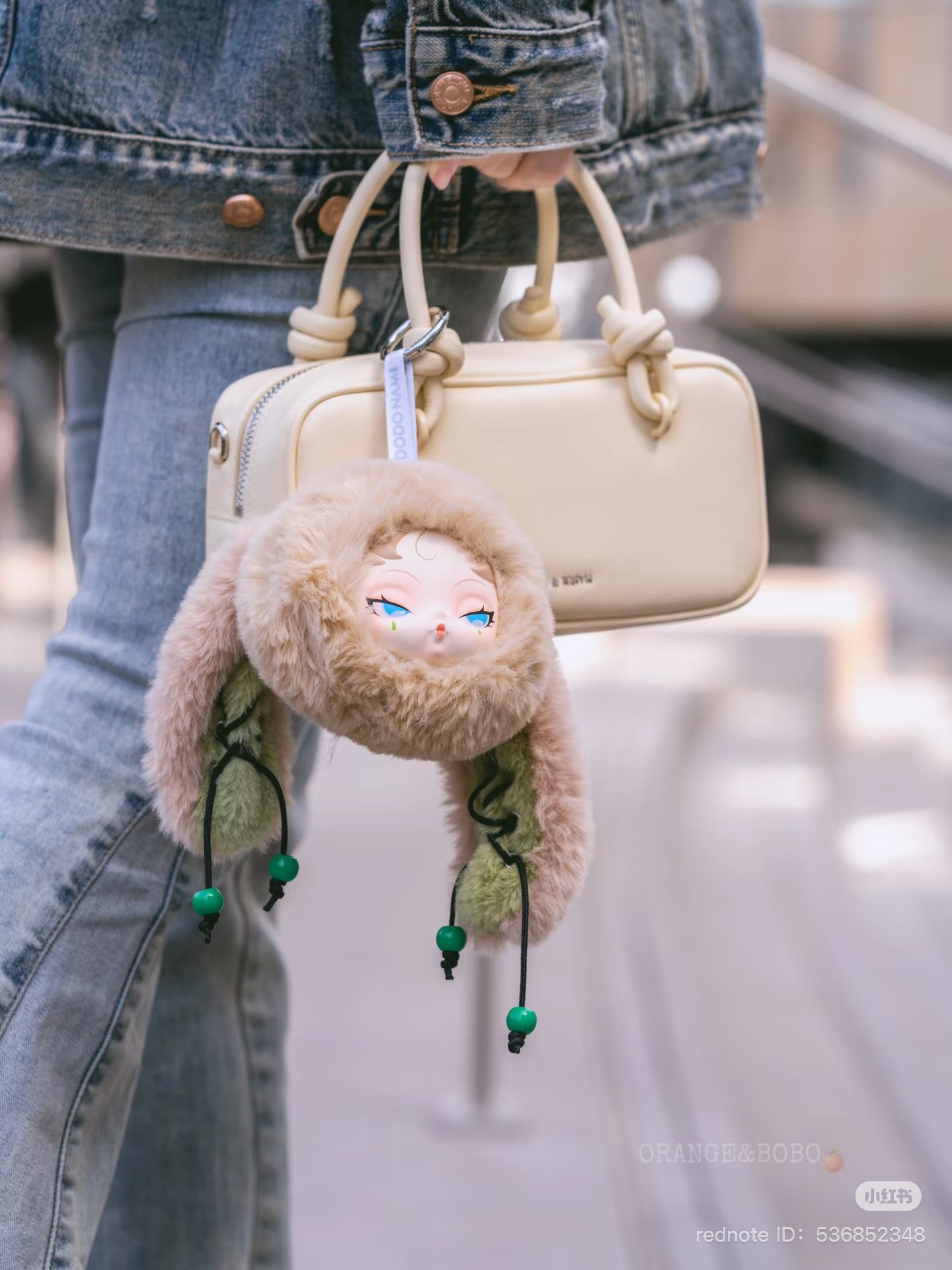 DODO NAMI Twinkle Bunny Series Plush Keychain Blind Box held by a person, showcasing a cute stuffed animal design as part of a collectible set.
