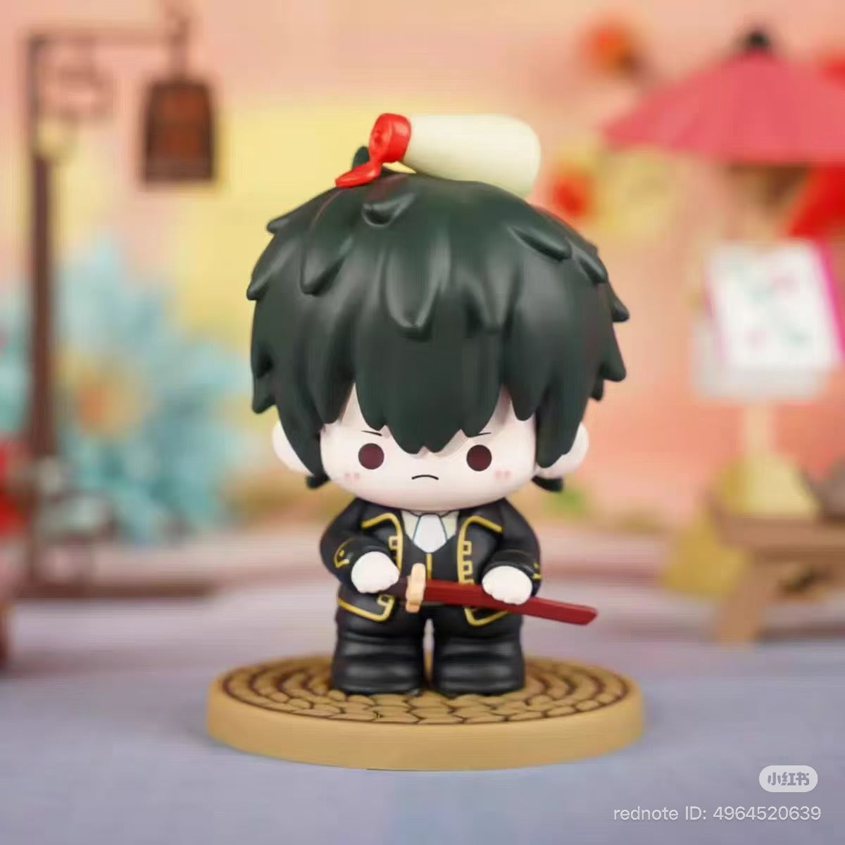 Gintama Moe Series Vol.1 Blind Box: Chibi figurine with black hair, dark jacket, red sword, and scroll on head, part of a 12-design collectible set.