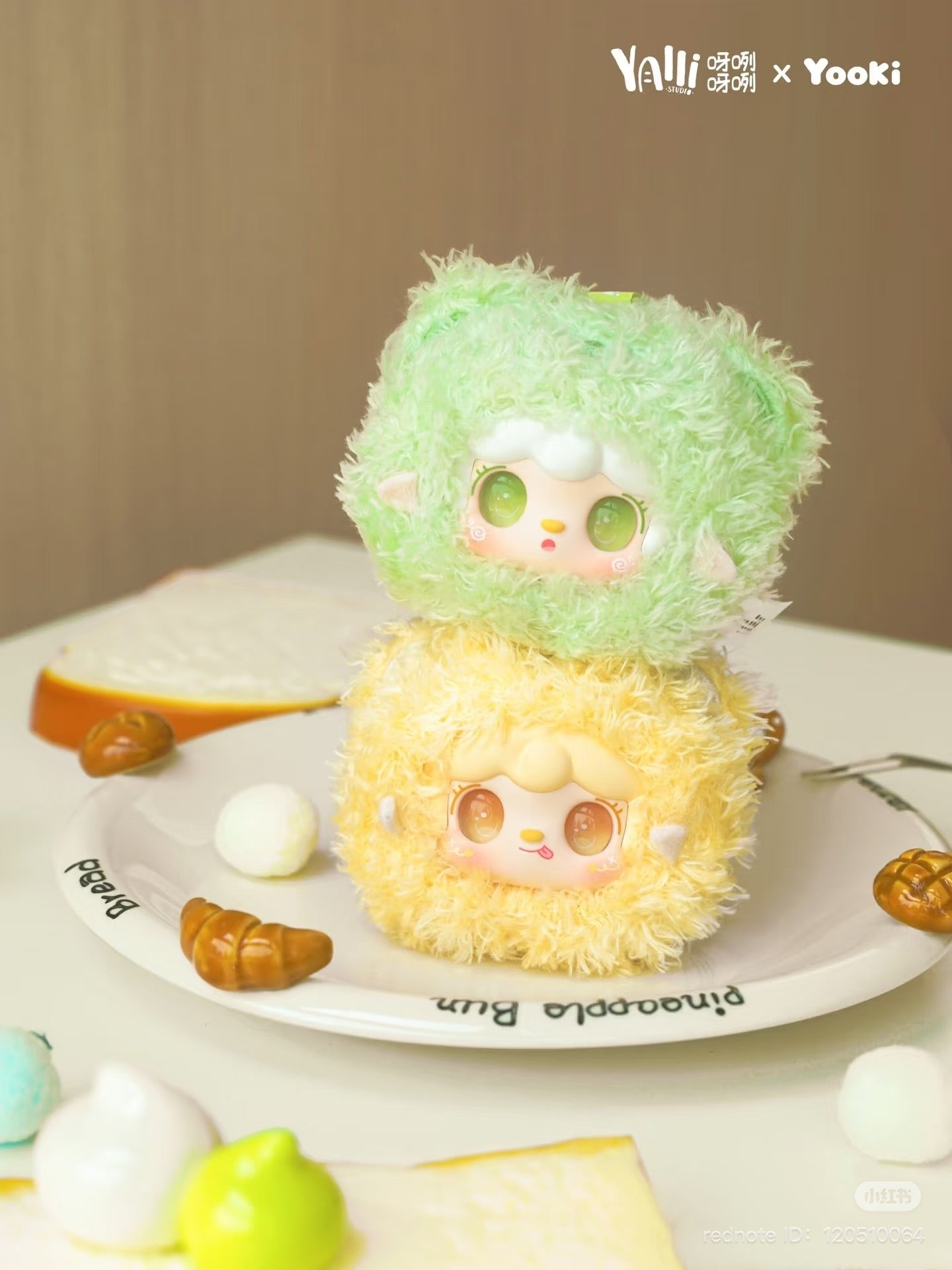 Yooki - Little Bear Bun Mini Keychain Plush Blind Box on a plate, featuring a yellow fluffy toy with a smiley face, available for preorder.