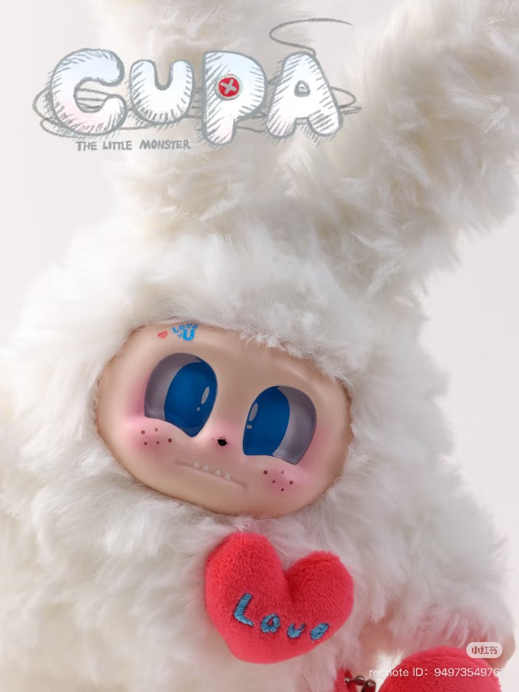 Cupa the Little Monster plush keychain featuring a white stuffed toy with a pink heart and blue eyes, part of a blind box series.
