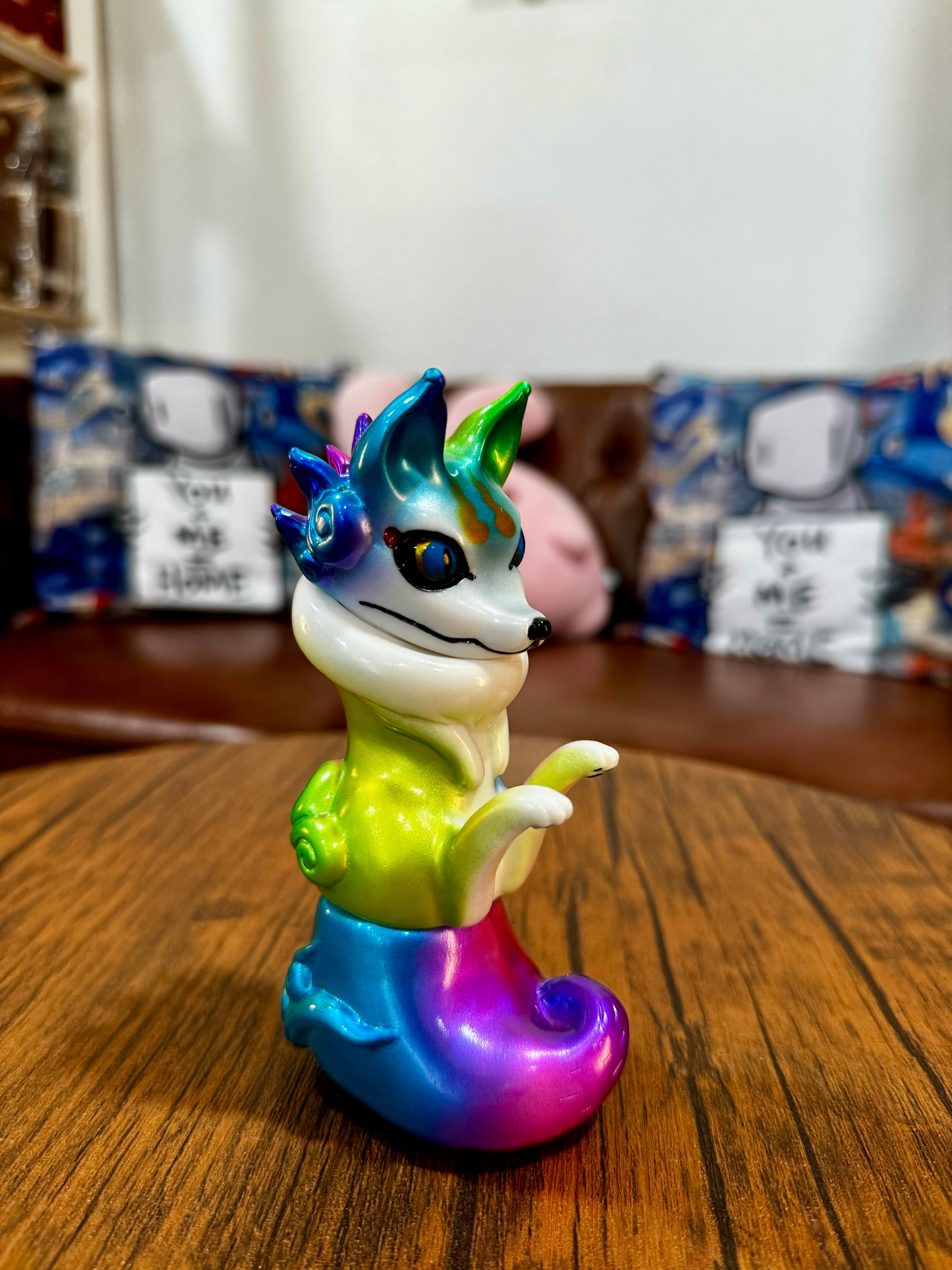Urukoma - Metallic Rainbow by YASU: A limited edition 13cm Japanese Sofubi animal figurine on a table, exclusive to 25 pieces.