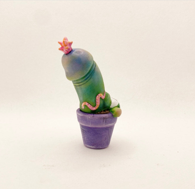 Toy cactus in pot with small purple elephant pot, close-up of toy.
