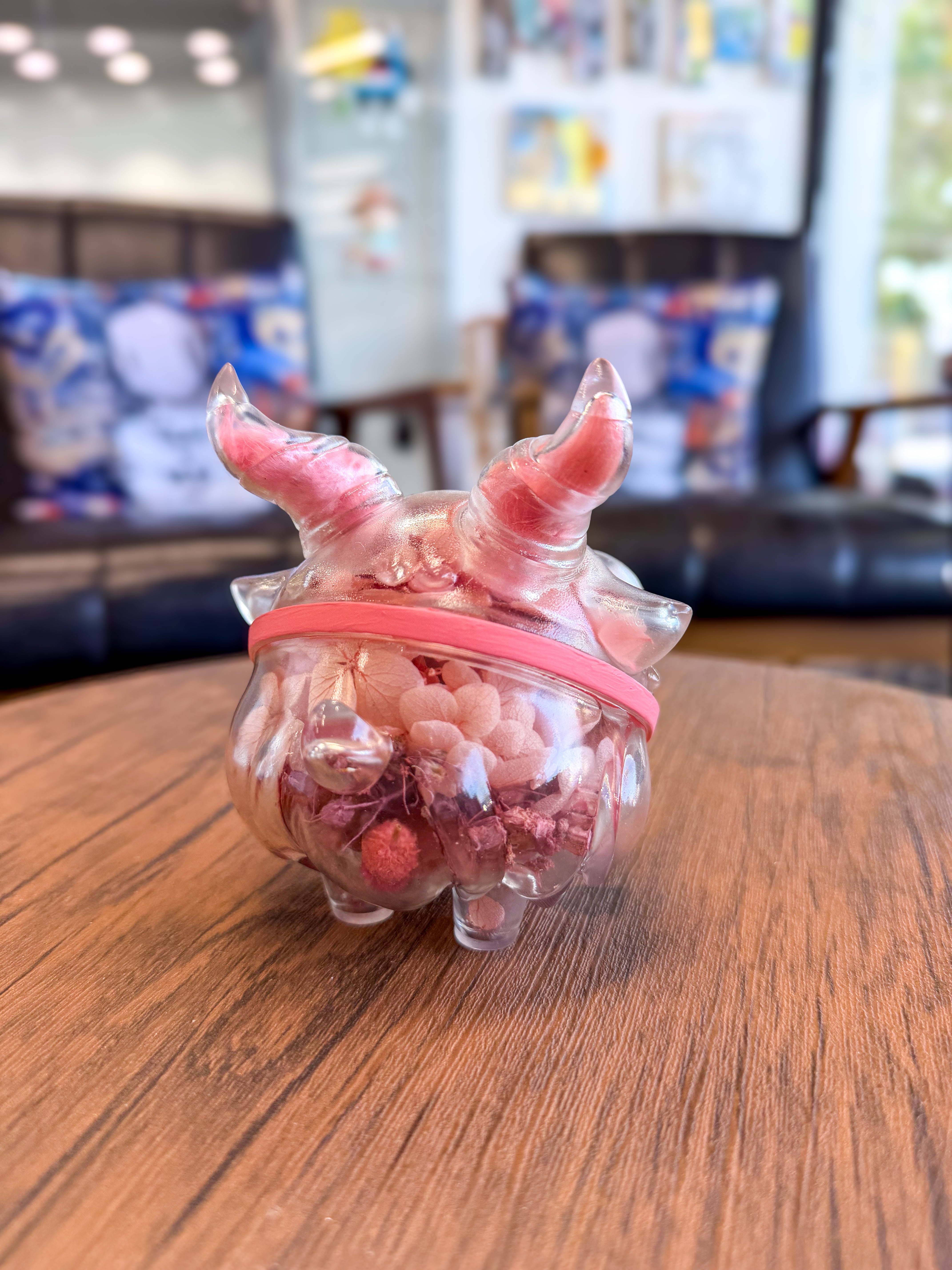 Sweet on the inside Bobbi by Zintears, a 10cm decorative container with horn-like details, holds dried botanicals, displayed on a wooden table.