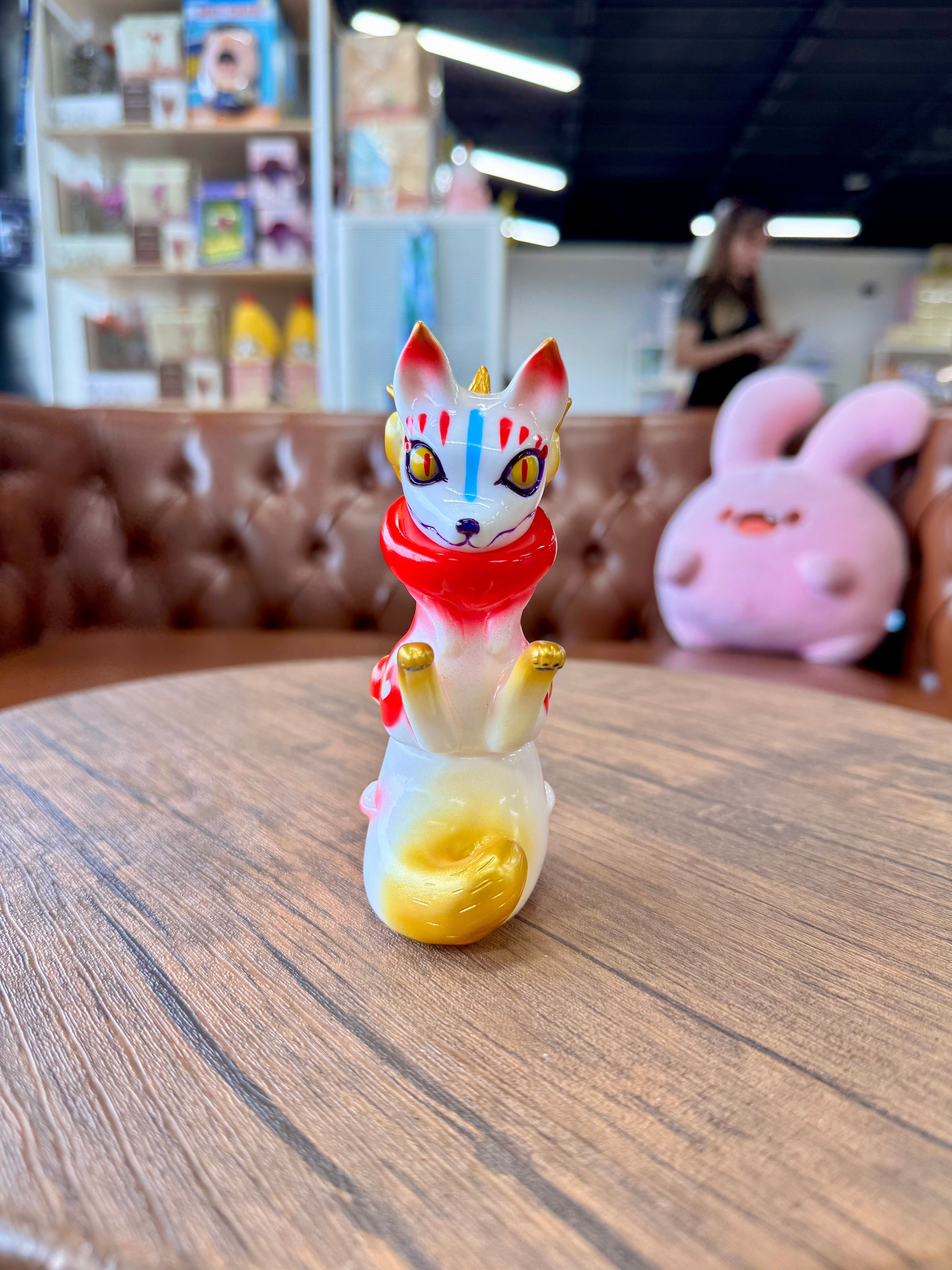 Urukoma - Inari by YASU, a 13cm Japanese Sofubi, featuring a small dog figurine on a table, ideal for art toy enthusiasts.