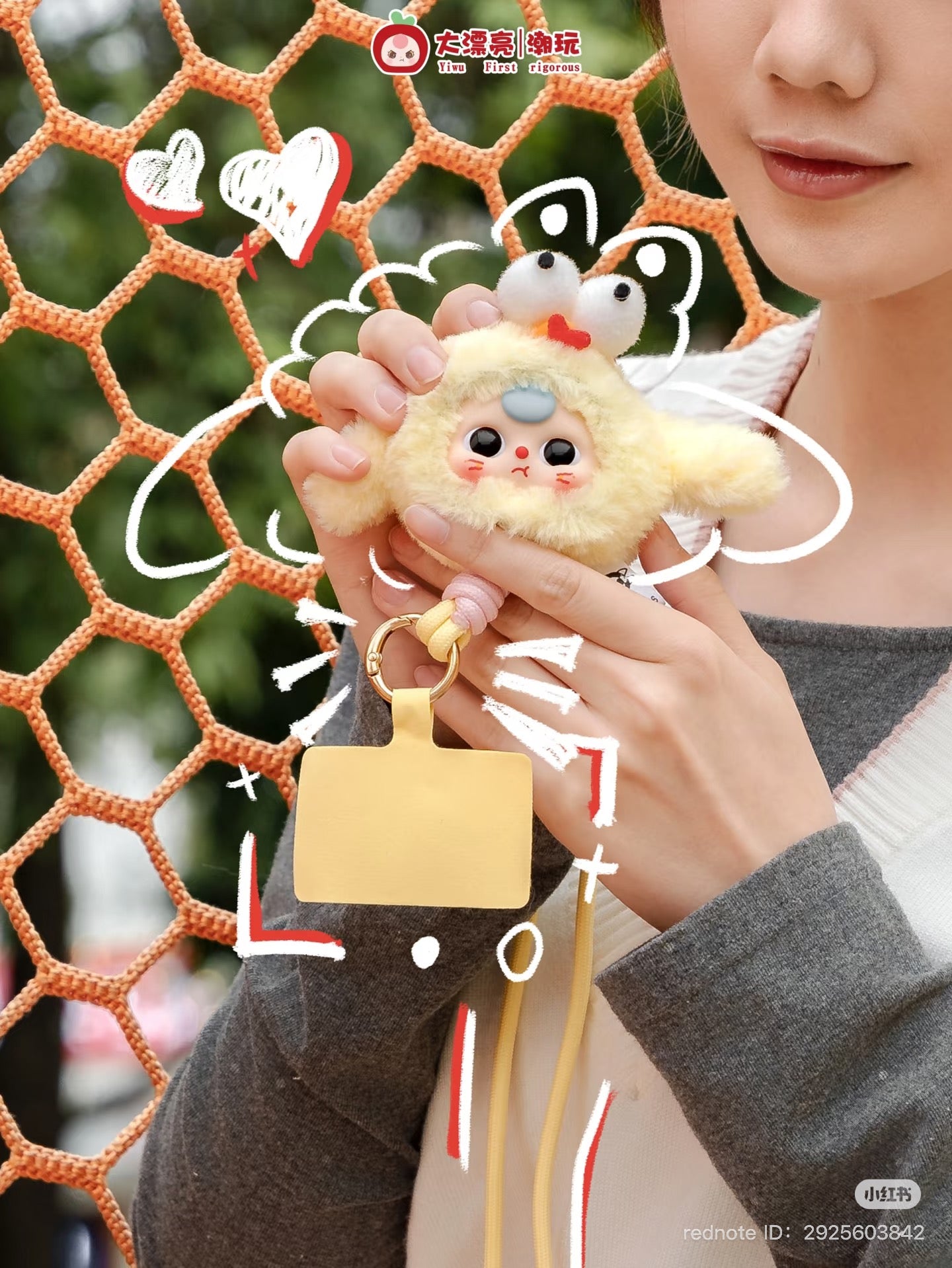Woman holding a Baby Three Mobile phone strap Plush Blind Box toy, part of a 12-design preorder series, available at Strangecat Toys.