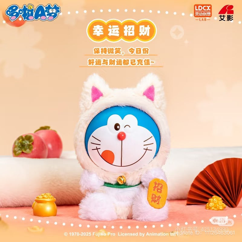 Doraemon-vol.1 Lucky Cat Plush Blind Box, featuring close-ups of fan, fruit, and toy elements. Preorder for 6 designs or a secret option. Ships Aug 2025.