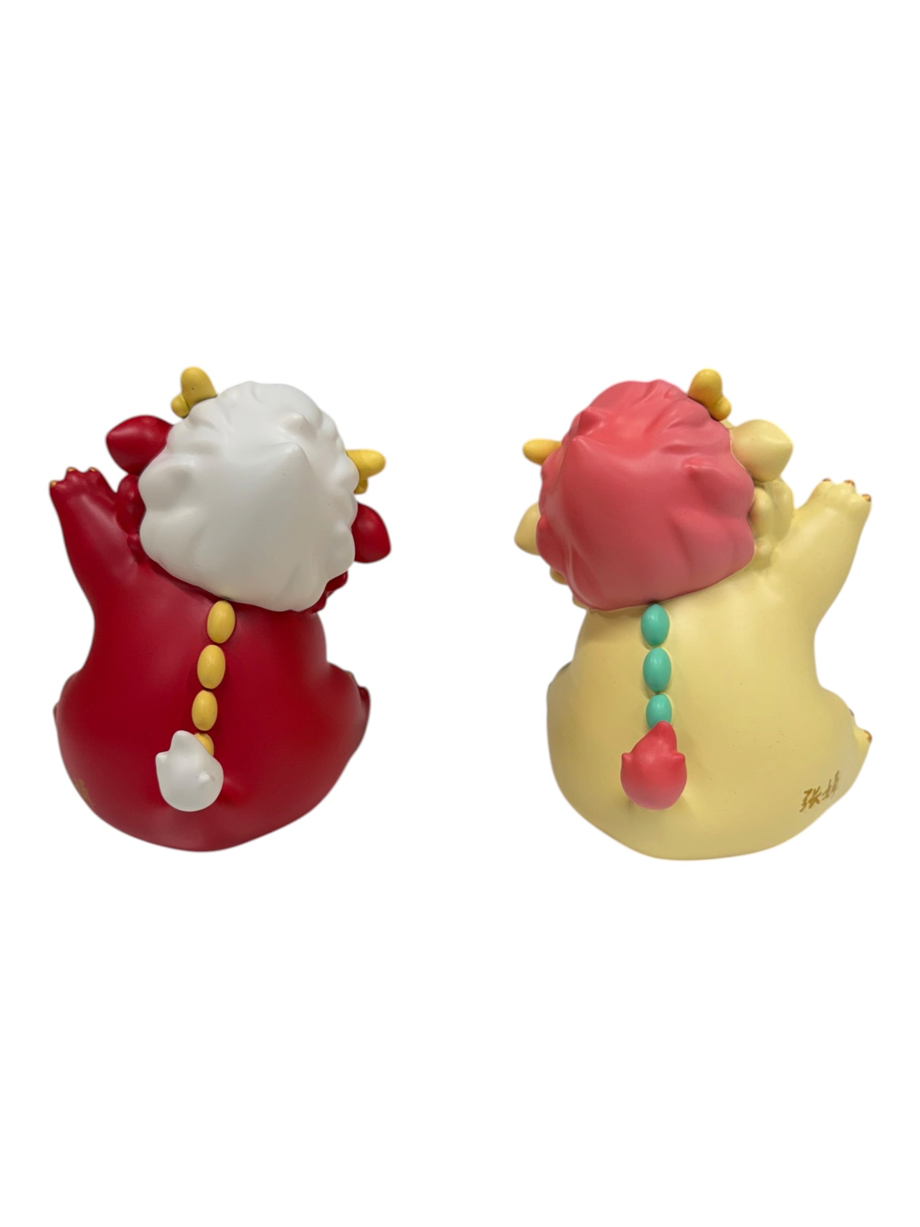 Kemelife Long figurines: two chubby resin collectibles, one red, one yellow, each with raised arms, tufted tails, and decorative mane and spine details.