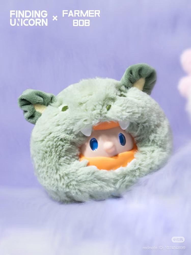 FARMER BOB Mini - DRAGON MIRAGE SERIES, featuring a fluffy-green creature head with a vinyl figure inside, showcasing bright-blue eyes and an orange beard.