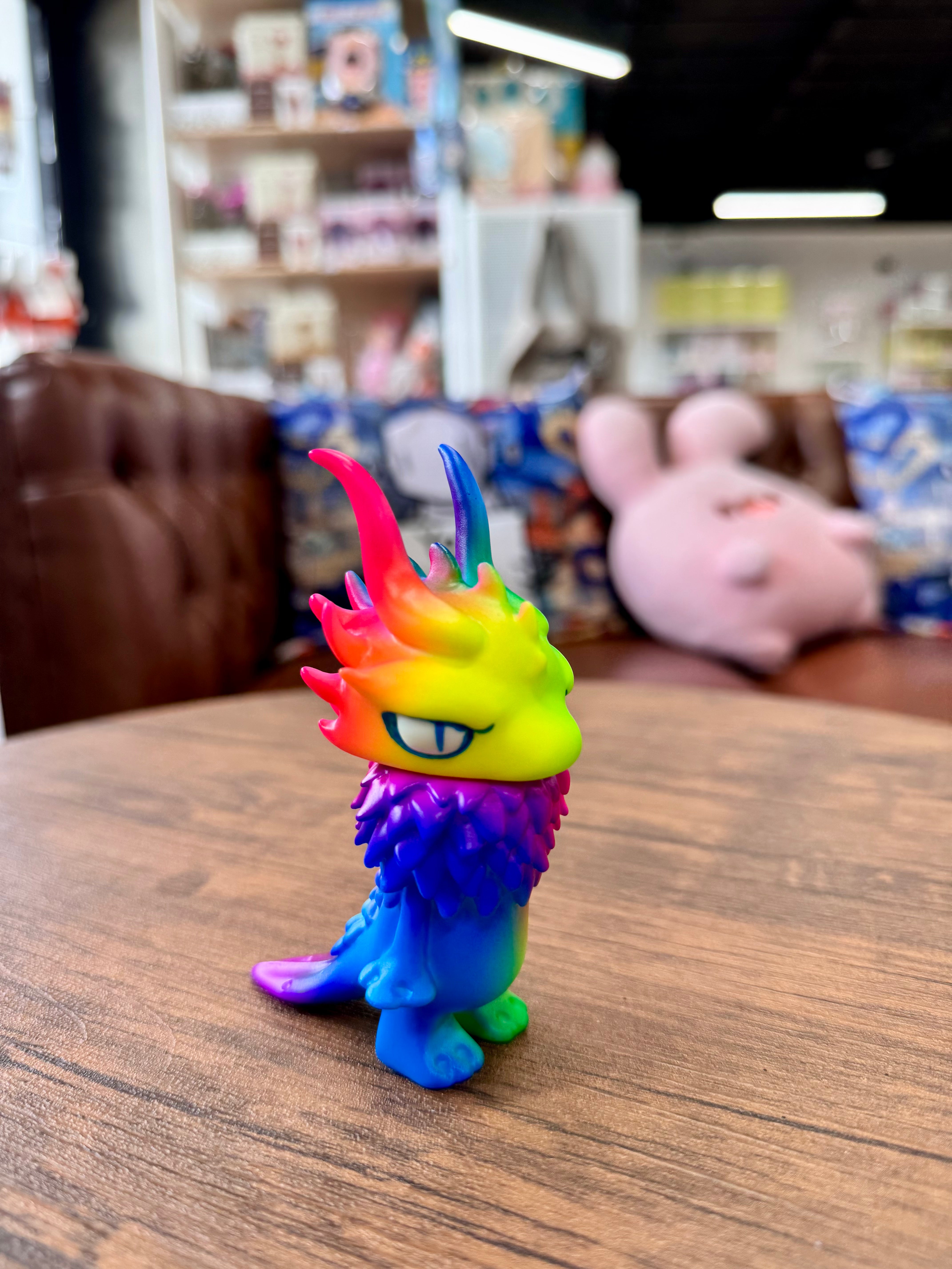 Gekko Dragon Fluorescent Color by YASU, a Japanese Sofubi toy, showcased on a table, highlighting its intricate design suitable for indoor display.