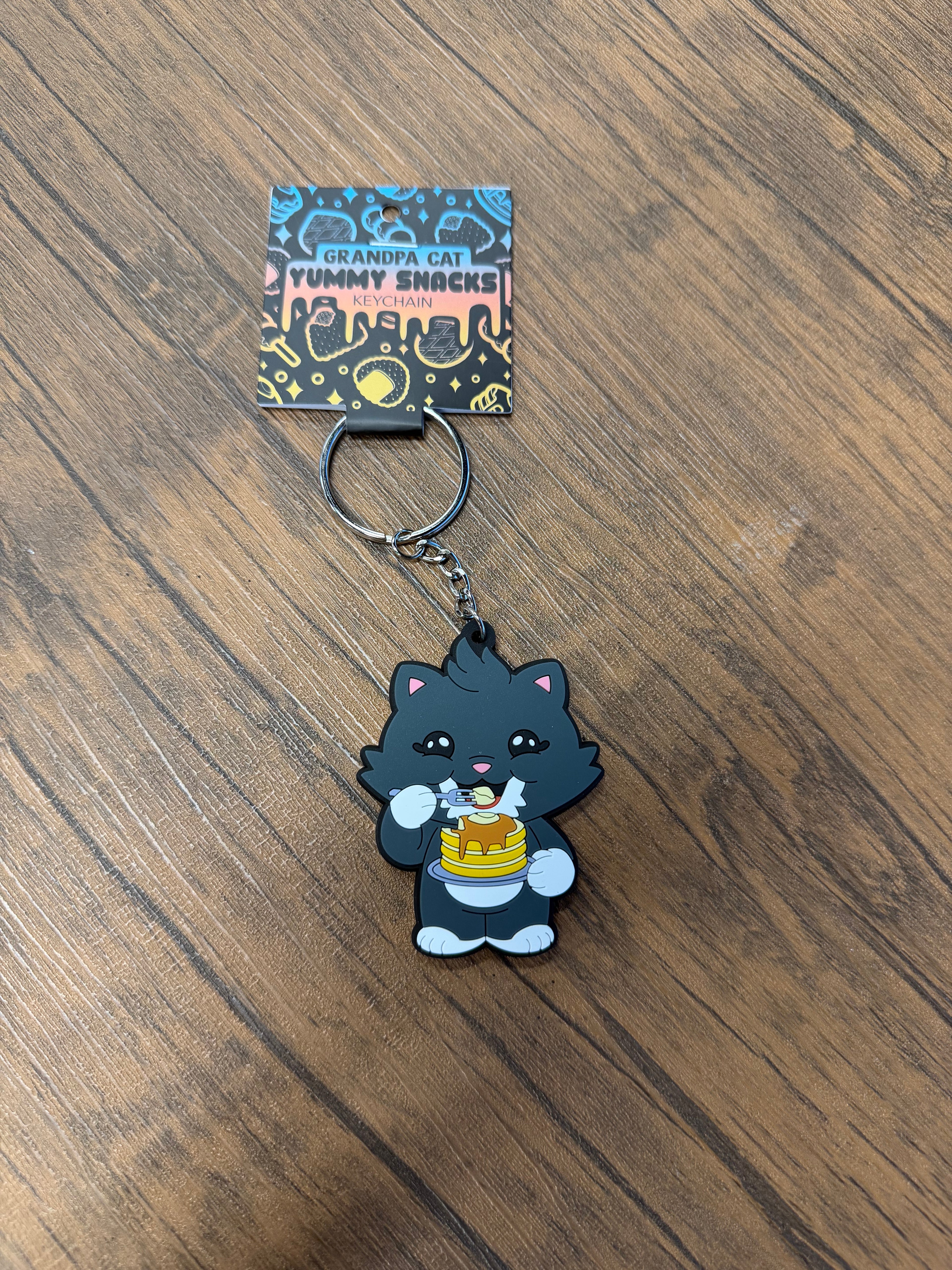 Grandpa Keychain - Japanese Snack Series: Cartoon cat with pancakes on a backing card, highlighting snack-themed novelty from Strangecat Toys.