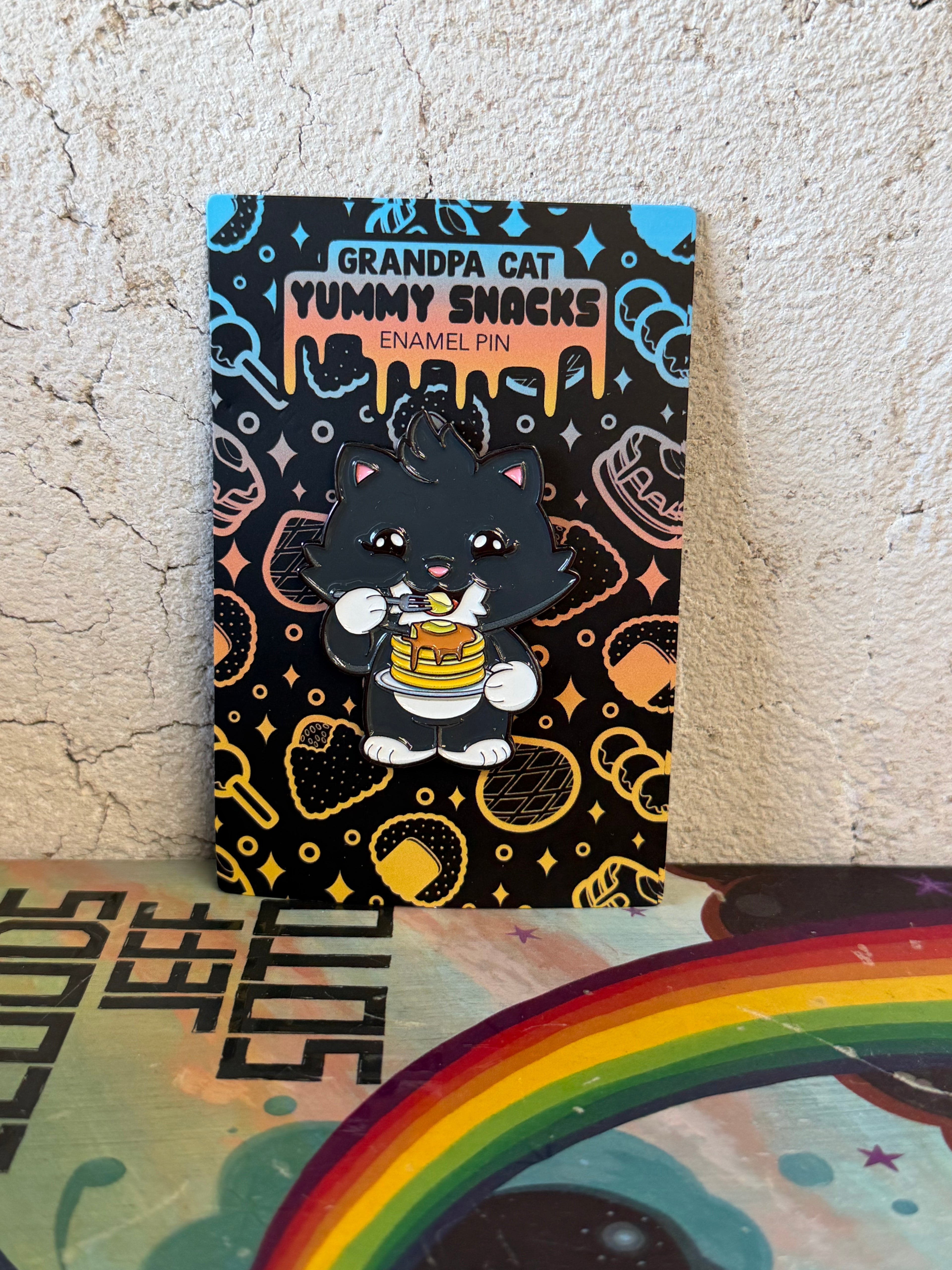 Grandpa Pin - Japanese Snack Series: Chibi black cat with fork and pancakes, displayed on a themed card with snack icons, by Strangecat Toys.