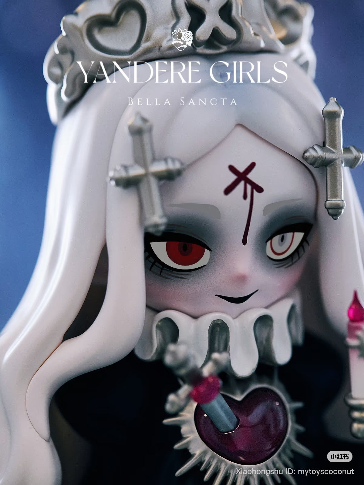 Yandere Girls Bella Sancta Preorder: Gothic vinyl figure with crown, mismatched eyes, and sacrificial heart motif. Creepy-cute blend, 9.6 inches tall, limited edition.